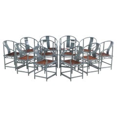 A set of 12 lacquered, rounded-back armchairs with cane seats, C. 1970.