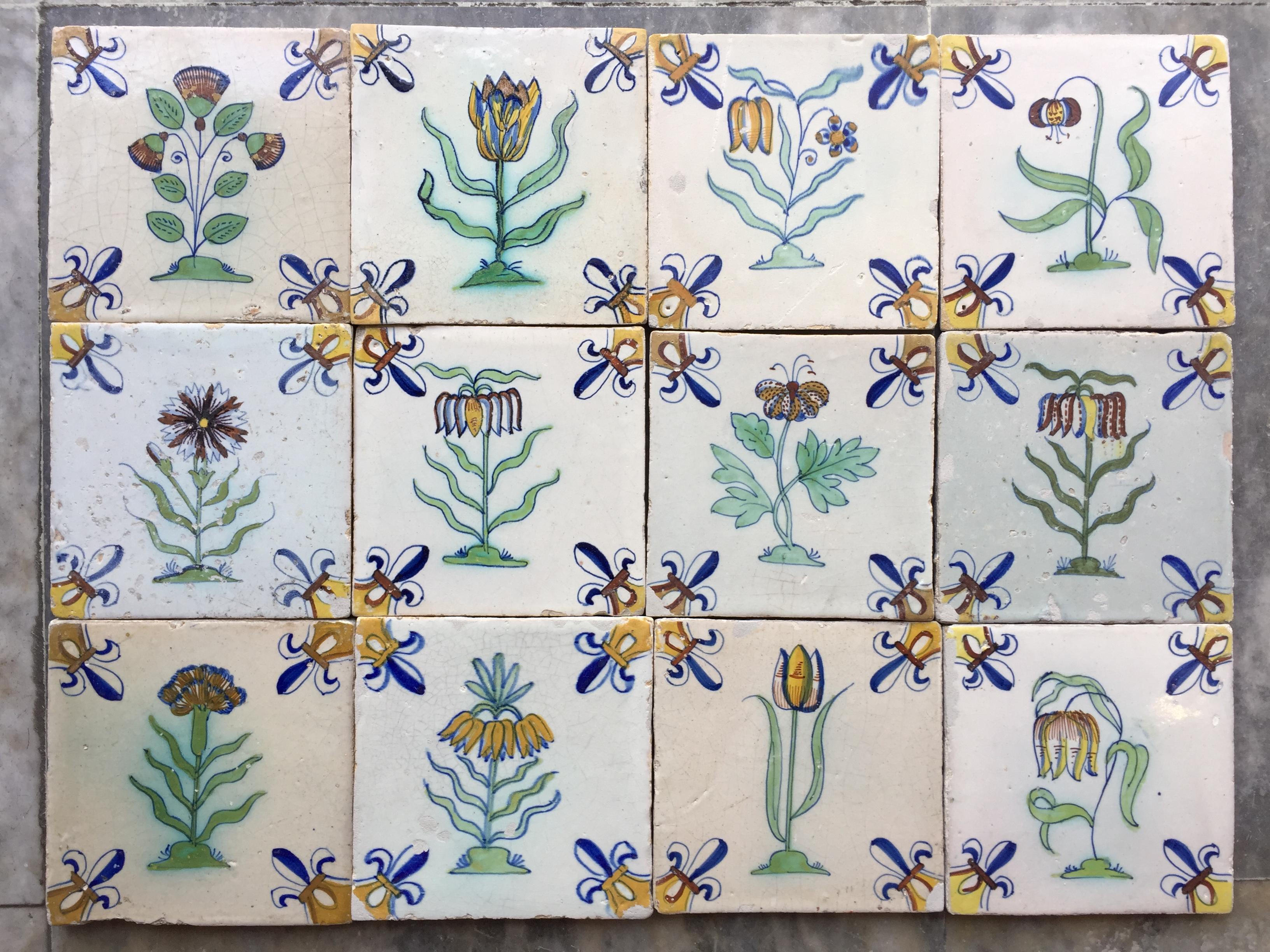 A rare set of 12 polychrome Dutch Delft tiles with flowers.
Made in The Netherlands.
Circa 1625 - 1650.

This set of tiles is of very fine quality and has a bright glaze. They date to the second quarter of the 17th century and where probably ment to