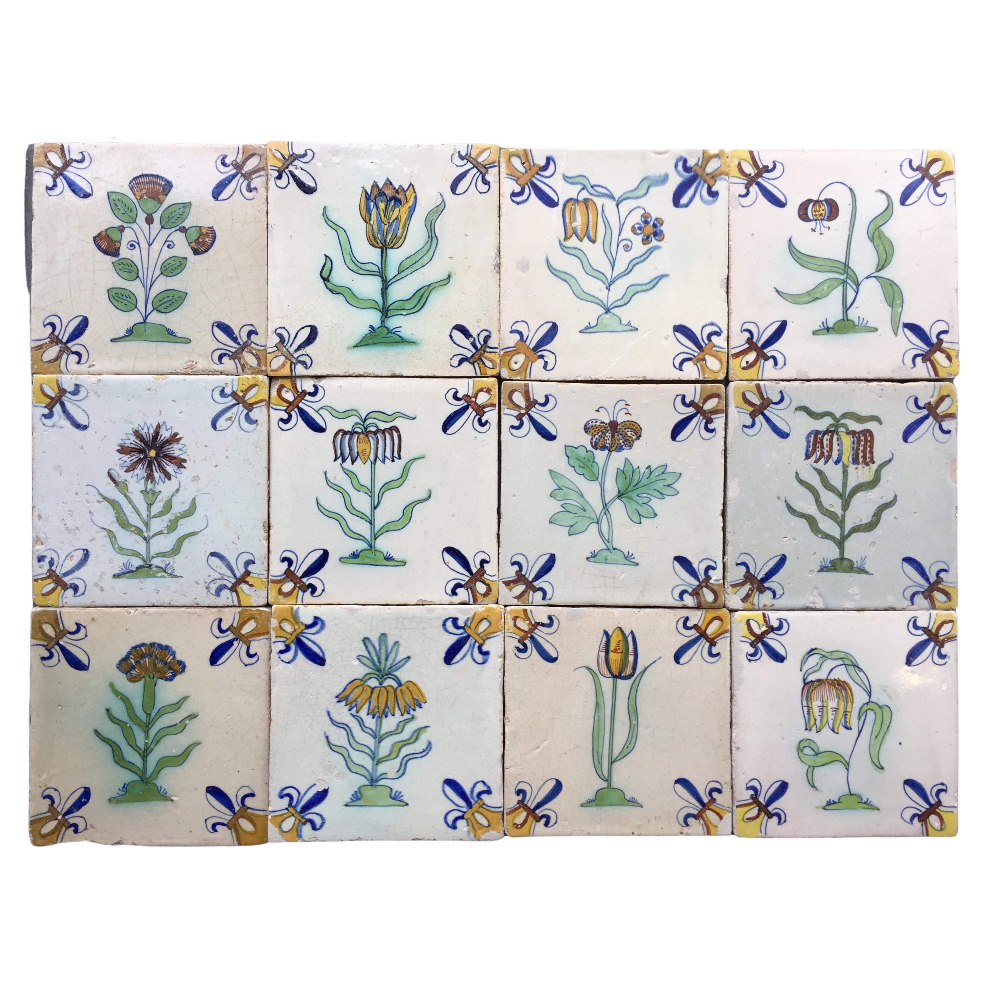 A set of 12 polychrome Dutch Delft tiles with flowers