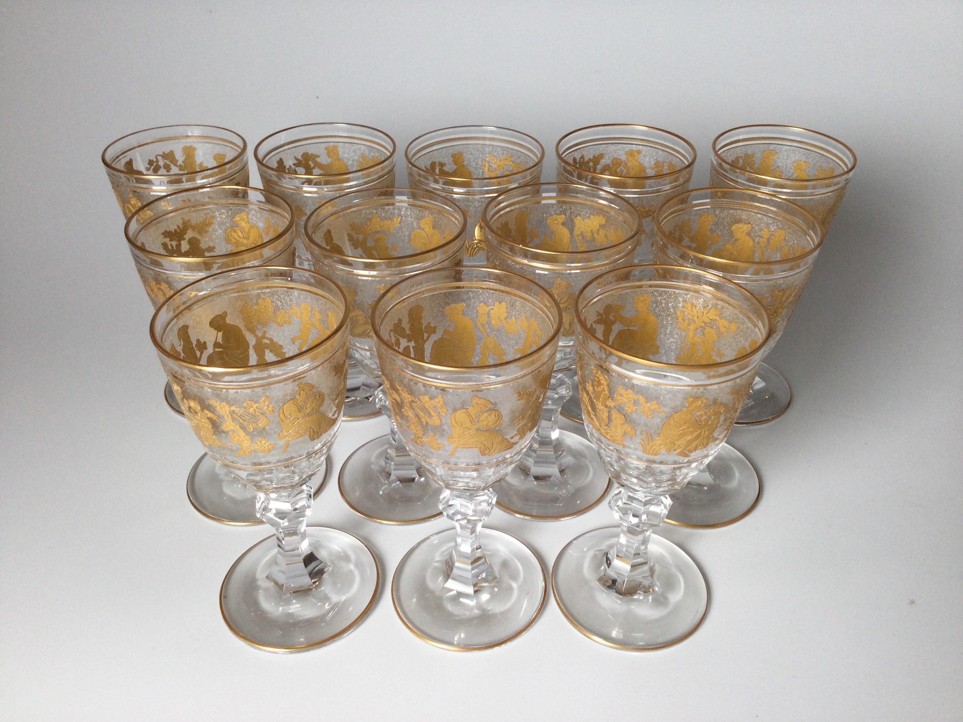 A magnificent set of 12 smaller wine or port goblets made by Val St. Lambert. Each one is handblown, panel cut bowl with cameo cut frieze of Roman figures embellished with gold leaf. This pattern is one of Val St. Lambert's finest and presents an