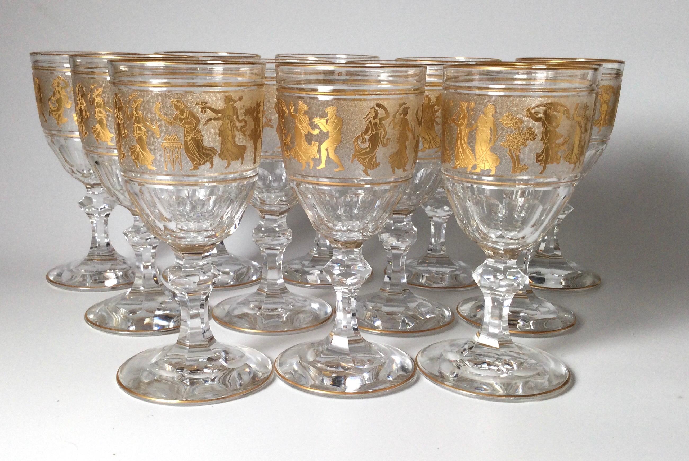 A magnificent set of 12 water or wine goblets made by Val St. Lambert. Each one is handblown, panel cut bowl with cameo cut frieze of Roman figures embellished with gold leaf. This pattern is one of Val St. Lambert's finest and presents an opulent