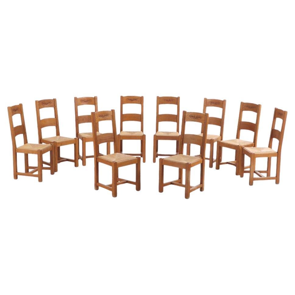A set of 14 French oak ladderback dining chairs, C. 1960.