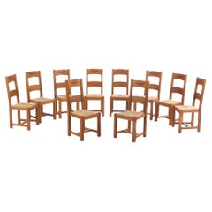 A set of 14 French oak ladderback dining chairs, C. 1960.