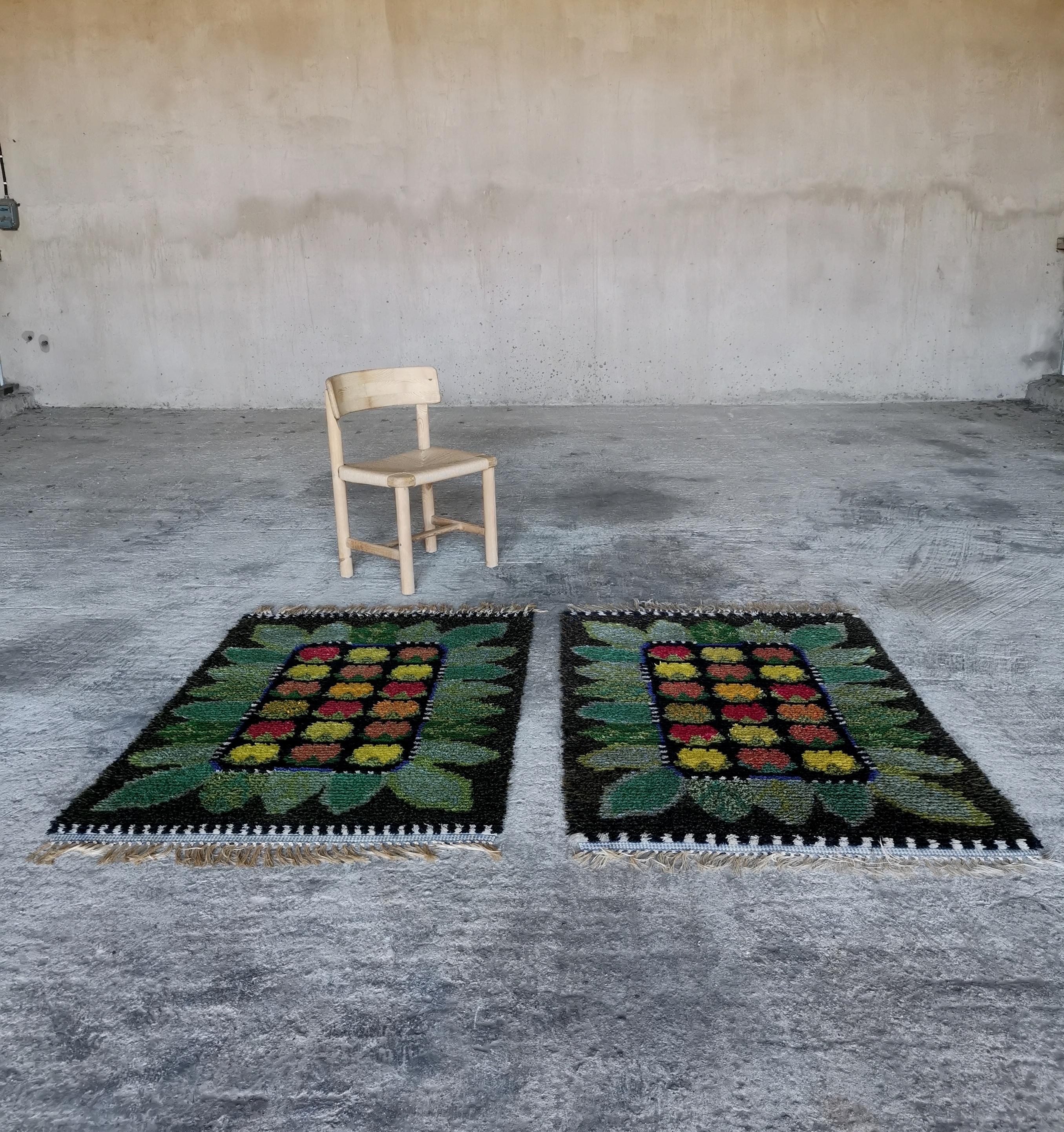 A set of midcentury modern Swedish Rya Wool Rugs
Pure wool in MINT condition. 
Vivid and colorful Fruit/Flower Motif. 

Dimensions:
( Please note one rug is 2 cm longer ) 
W: 100 cm 
L: 170/172 cm with tassels
L: 150/152 cm without tassels

Both