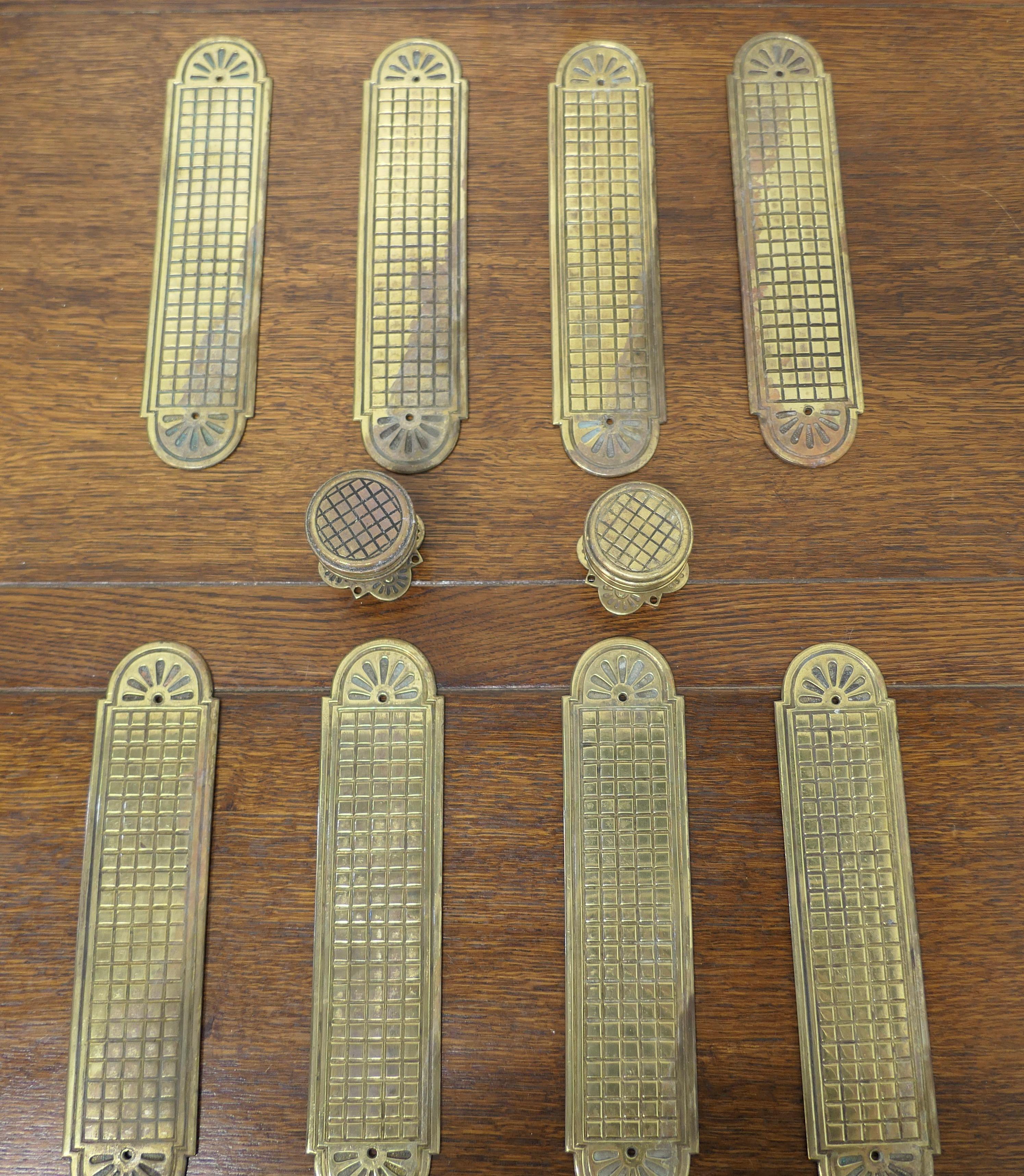 A set of 19th century Arts and Crafts brass door finger plates and knobs

There are 8 identical plates in this set, they are heavy and made in heavy brass, they have a lattice decoration and the top and bottom have a rounded shape, they have 2