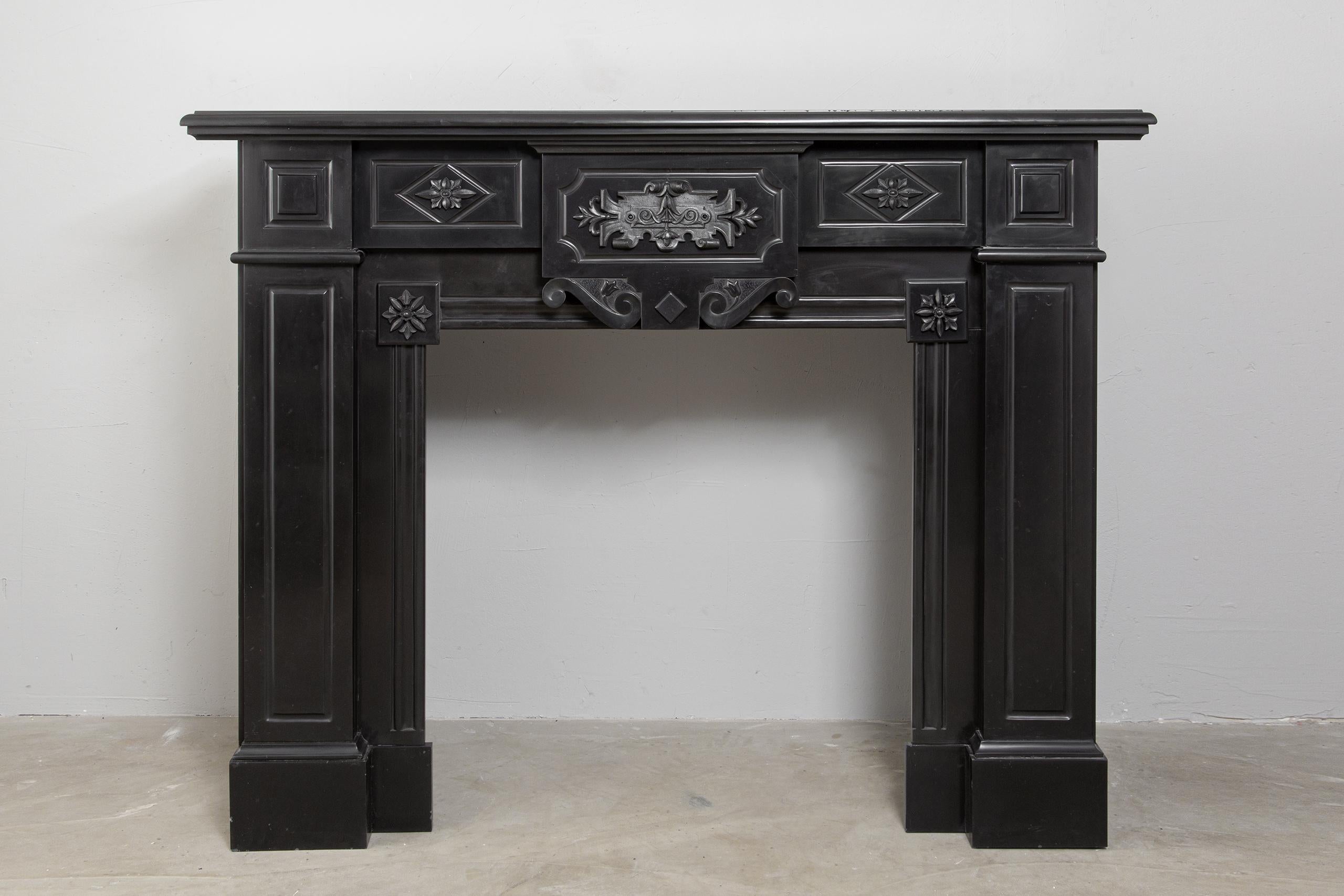 A beautiful set of two antique black marble fireplaces. The fireplaces are in beautiful condition. The fireplaces are richly decorated with iron attachments. These give the fireplaces a powerful appearance. The detailing and quality of the