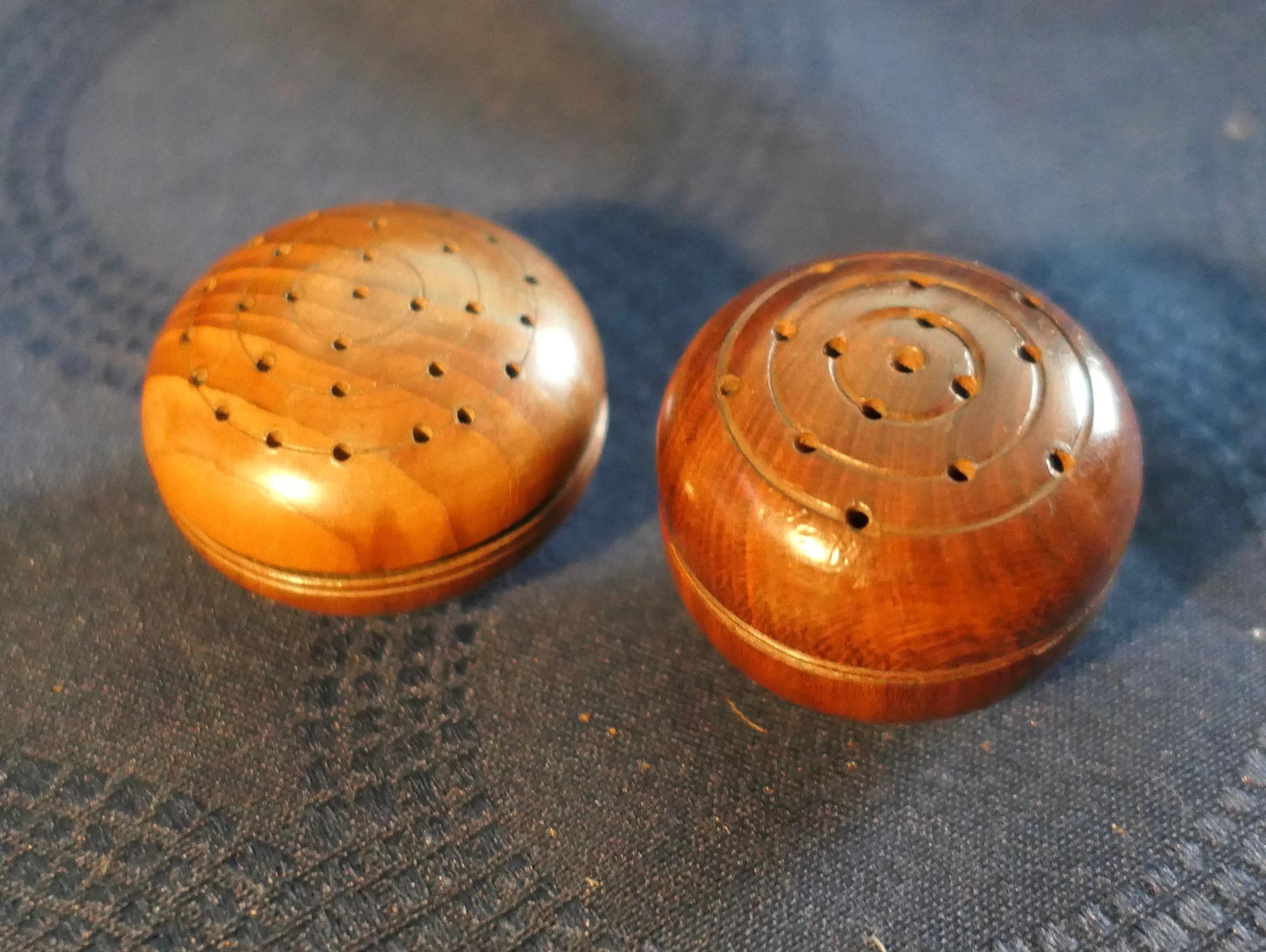 A Set of 2 Treen Pomanders in Yew Wood

2 small round early 19th century yew wood lady's pomanders, these unscrew in the centre with scent holes to both sides. one of these has what seems to be the original scent sponge, past its best now but