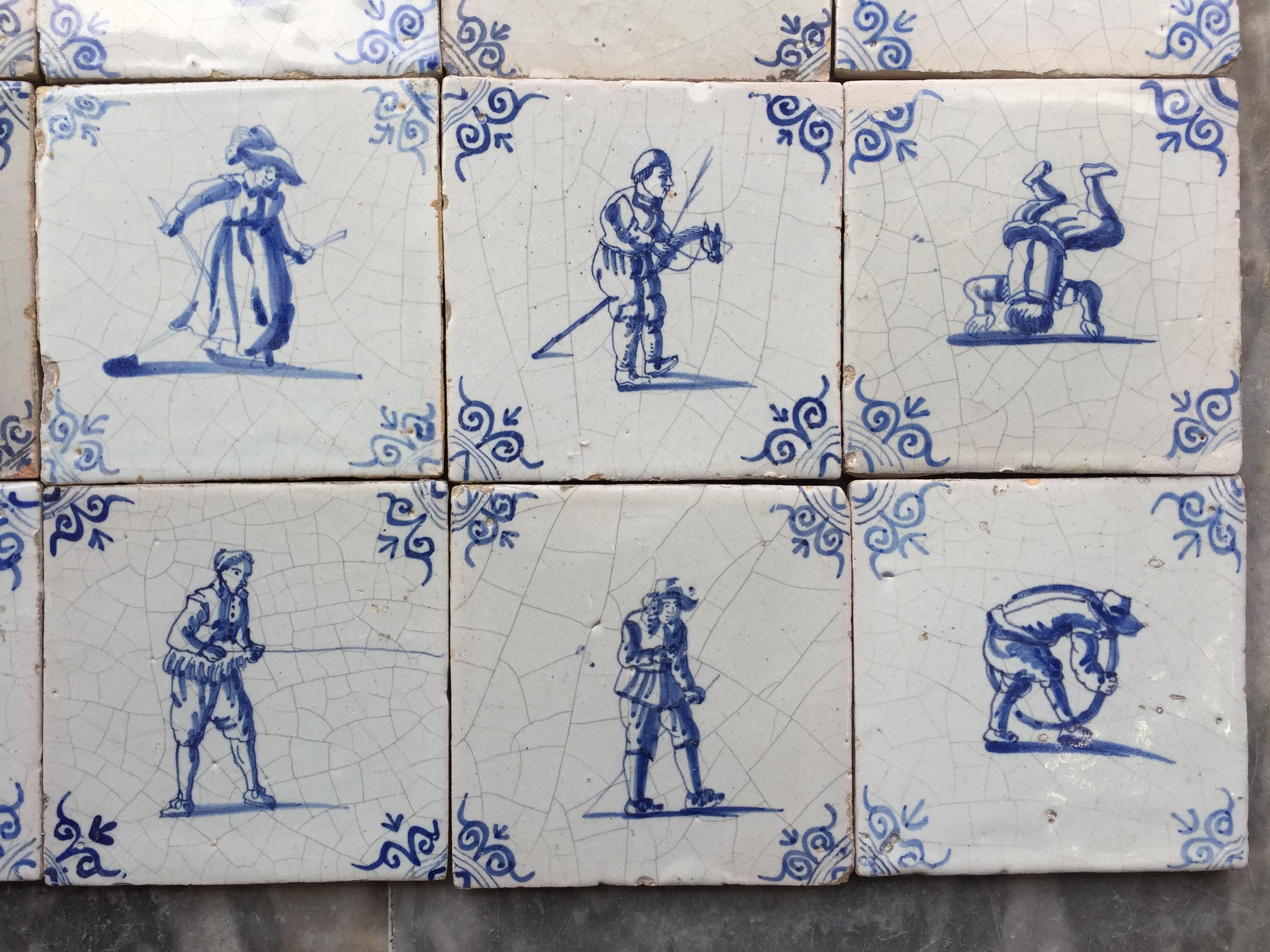 17th Century A set of 20 blue and white Dutch Delft tiles with figures and craftsmen