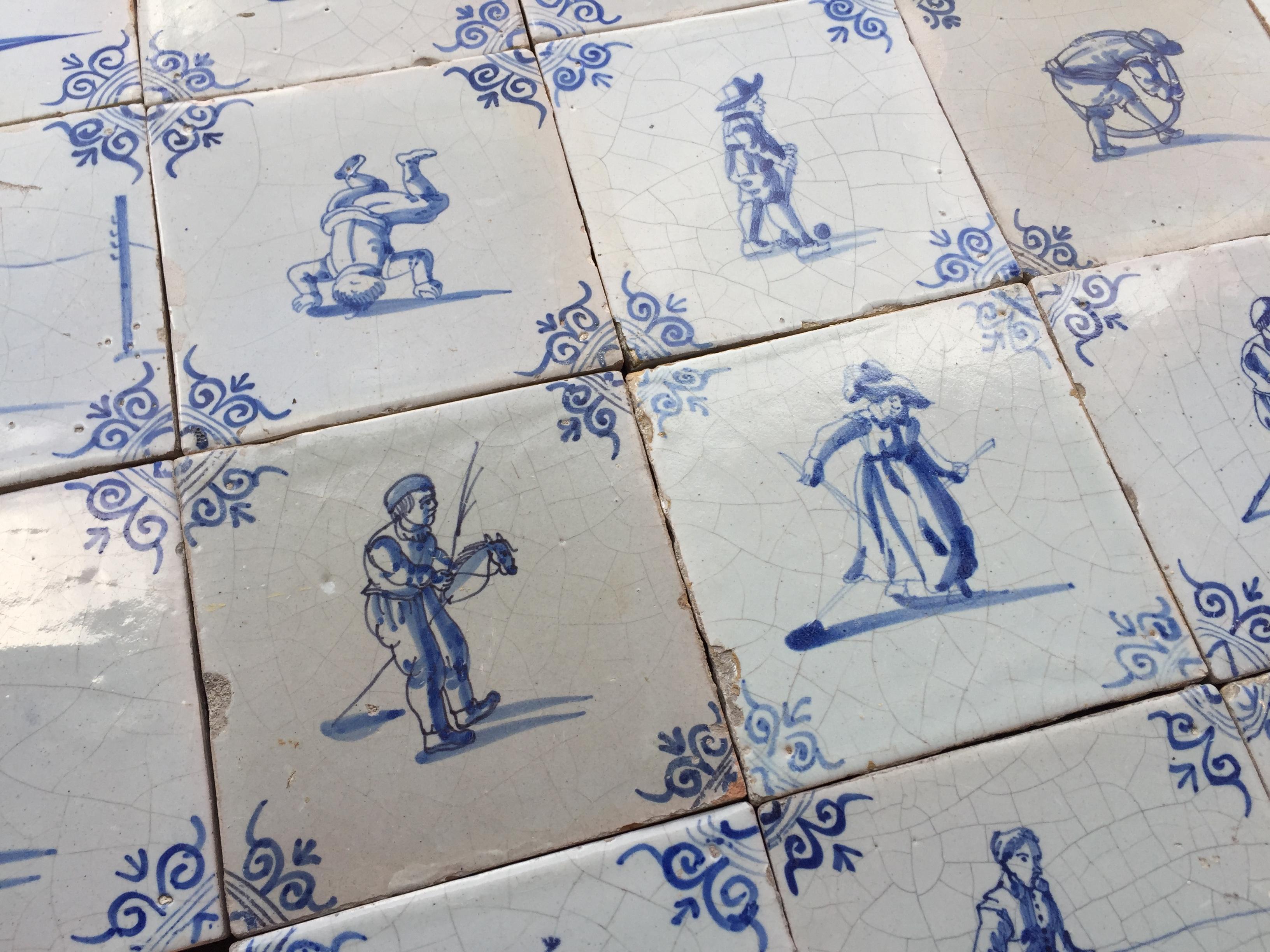 Ceramic A set of 20 blue and white Dutch Delft tiles with figures and craftsmen