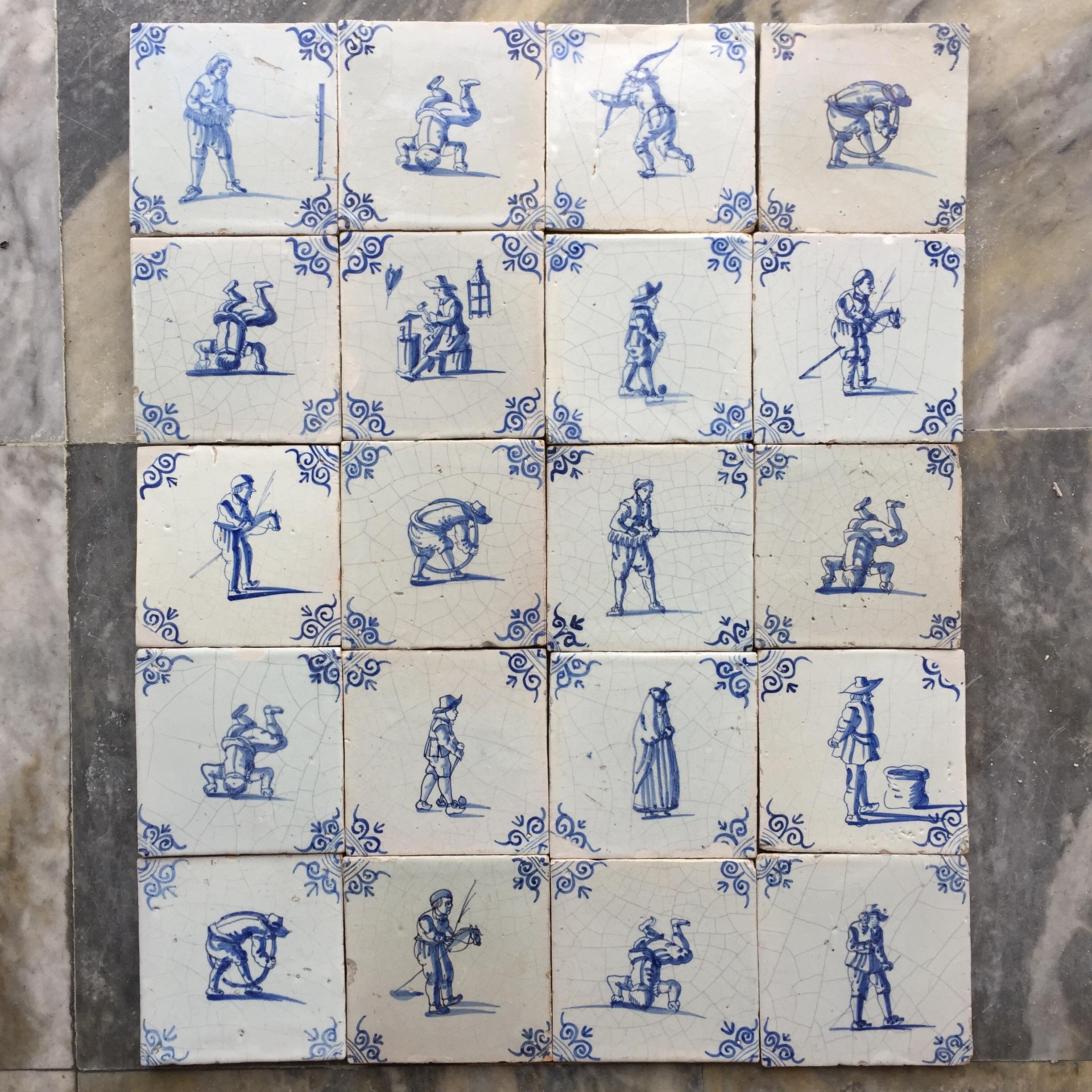 A set of 20 blue and white Dutch Delft tiles with figures and craftsmen 1