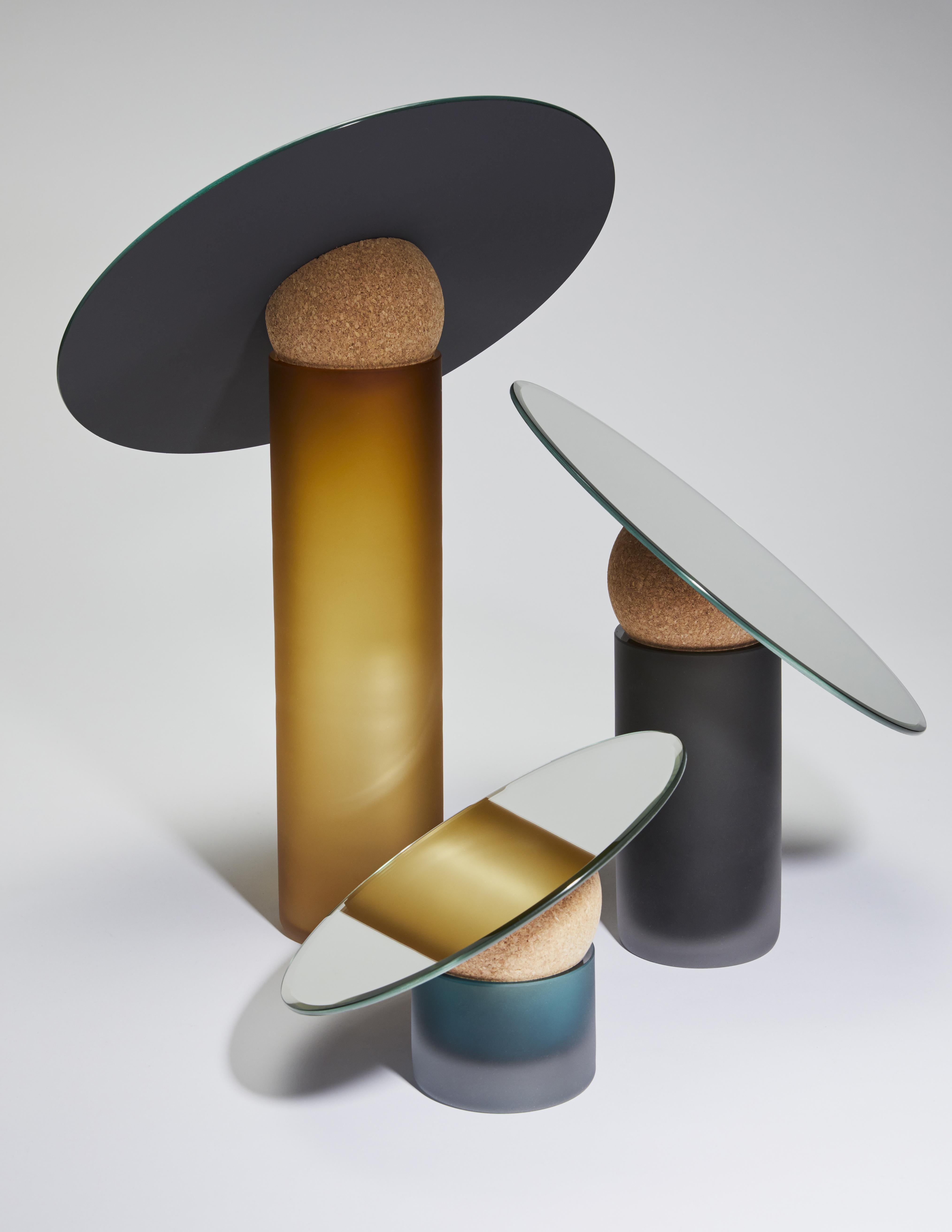 A set of 3 astra table mirrors by Clemence Birot
Dimensions: Ø 34 x 50 cm; Ø 30 x 33 cm; Ø 24 x 20 cm.
Materials: mirror, glass, cork. 

Clemence Birot started her career in Copenhagen, Denmark, and discovered a design practice closely related