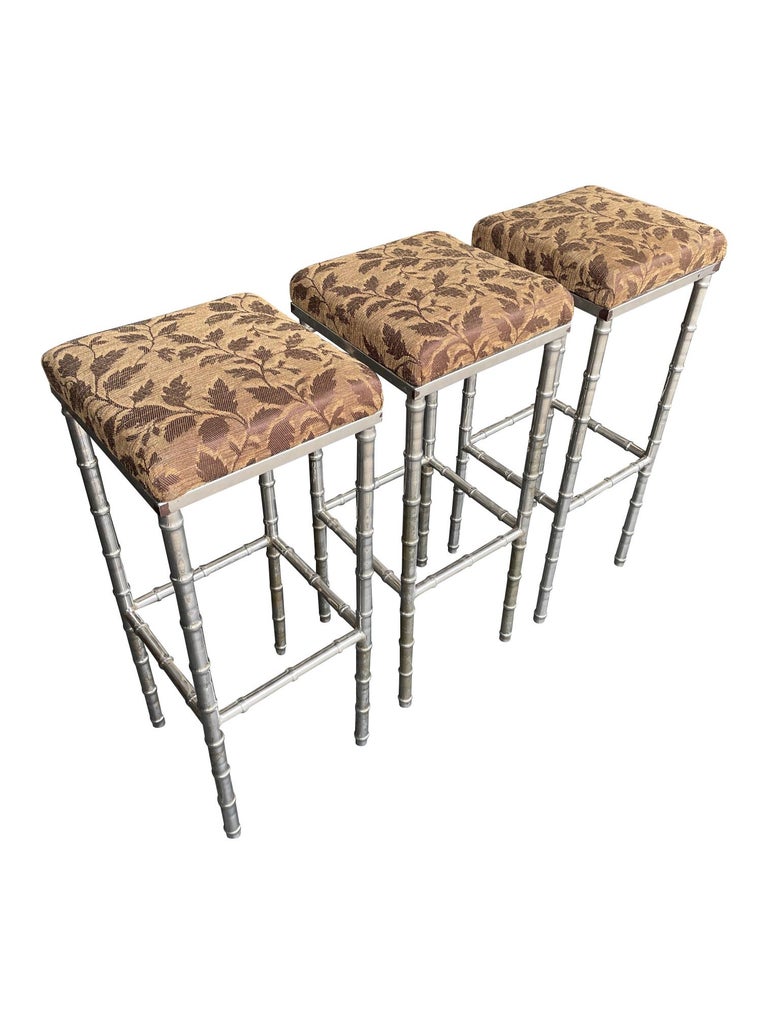 A set of 3 French 1960s faux bamboo chrome barstools with original leaf fabric. 

The bar in the last two photos is not part of this listing.