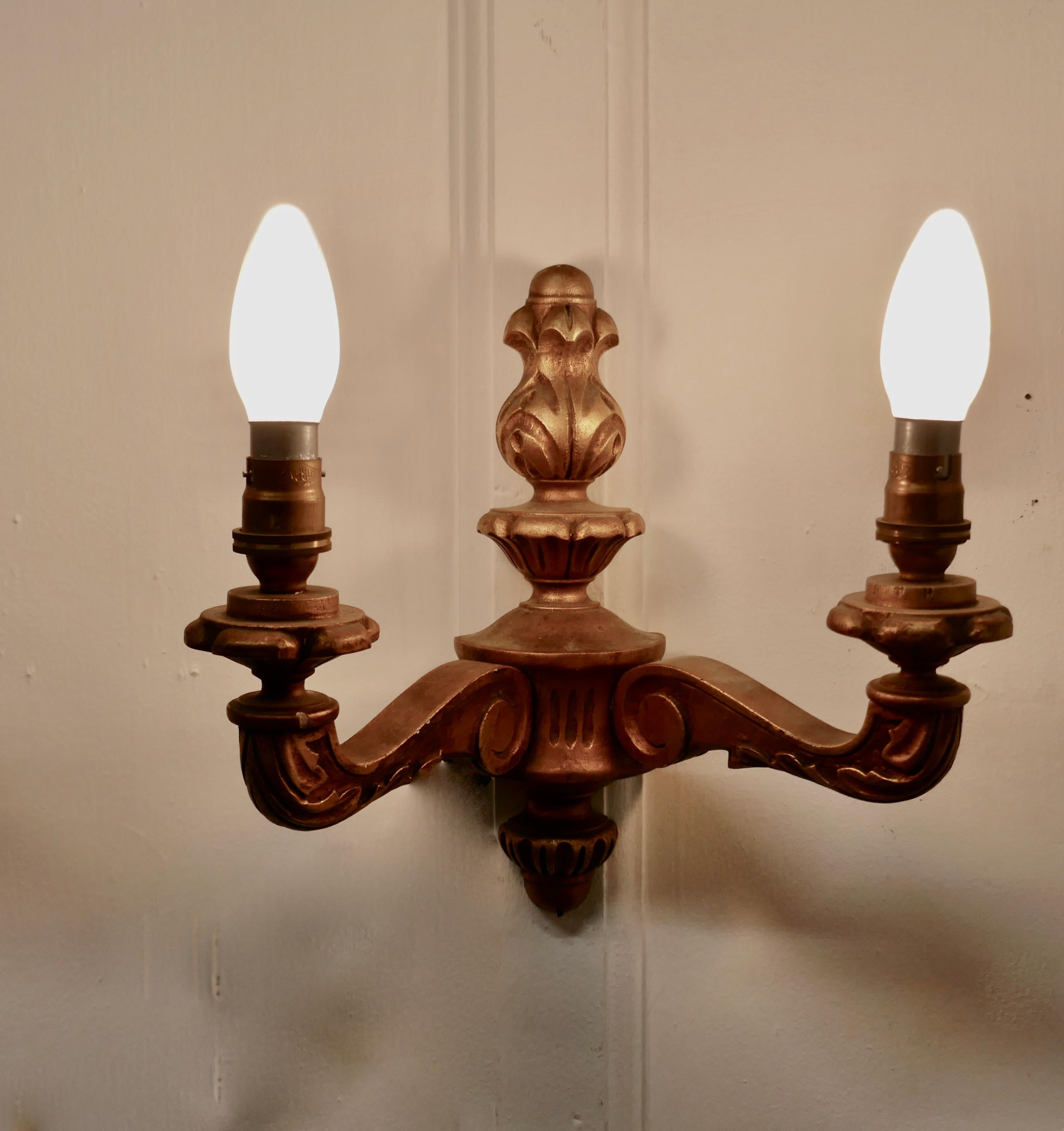A set of 3 giltwood carved twin wall lights


This is a very attractive set of lights they each have 2 sconces 

The lights are in good vintage condition and working, however they will have to be installed by an electrician

The lights are