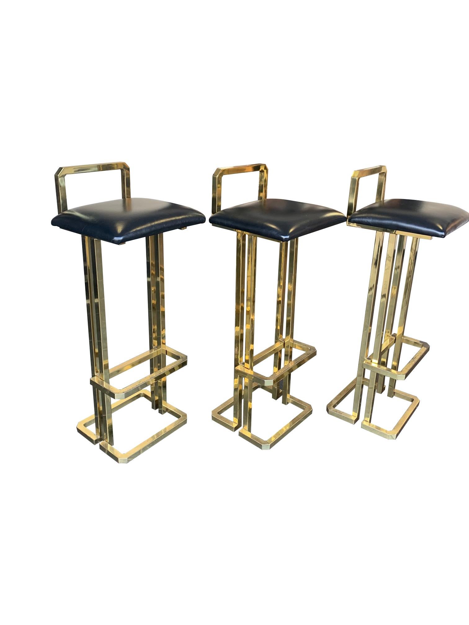 Mid-Century Modern Set of 3 Maison Jansen Style Gilt Metal Stools with Black Leather Seat Pads For Sale