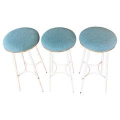 A set of 3 Mid-Century Bar Stools, White Metal, Brass and Pastel Blue Upholstery