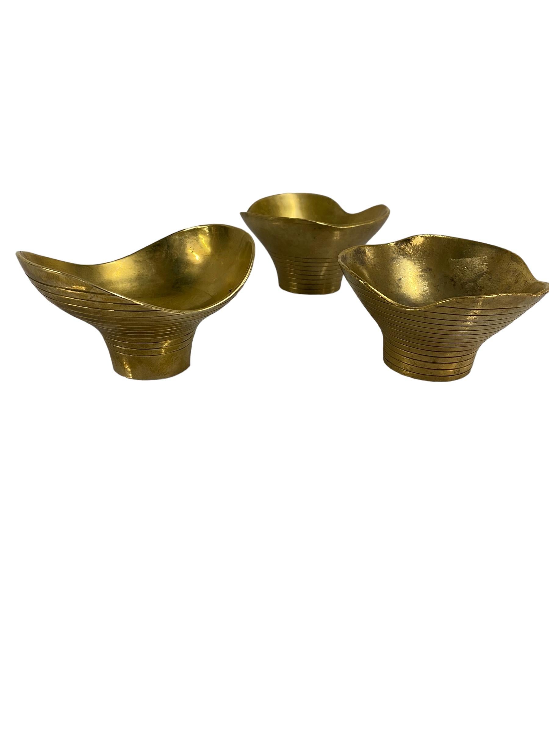 A set of 3 solid brass decorative bowls/objects, designed together by Paavo and Helena Tynell, and manufactured by Taito Oy in Finland in the 1940s. Before Paavo Tynell was known as the man who `illuminated Finland´, and early in his career he used