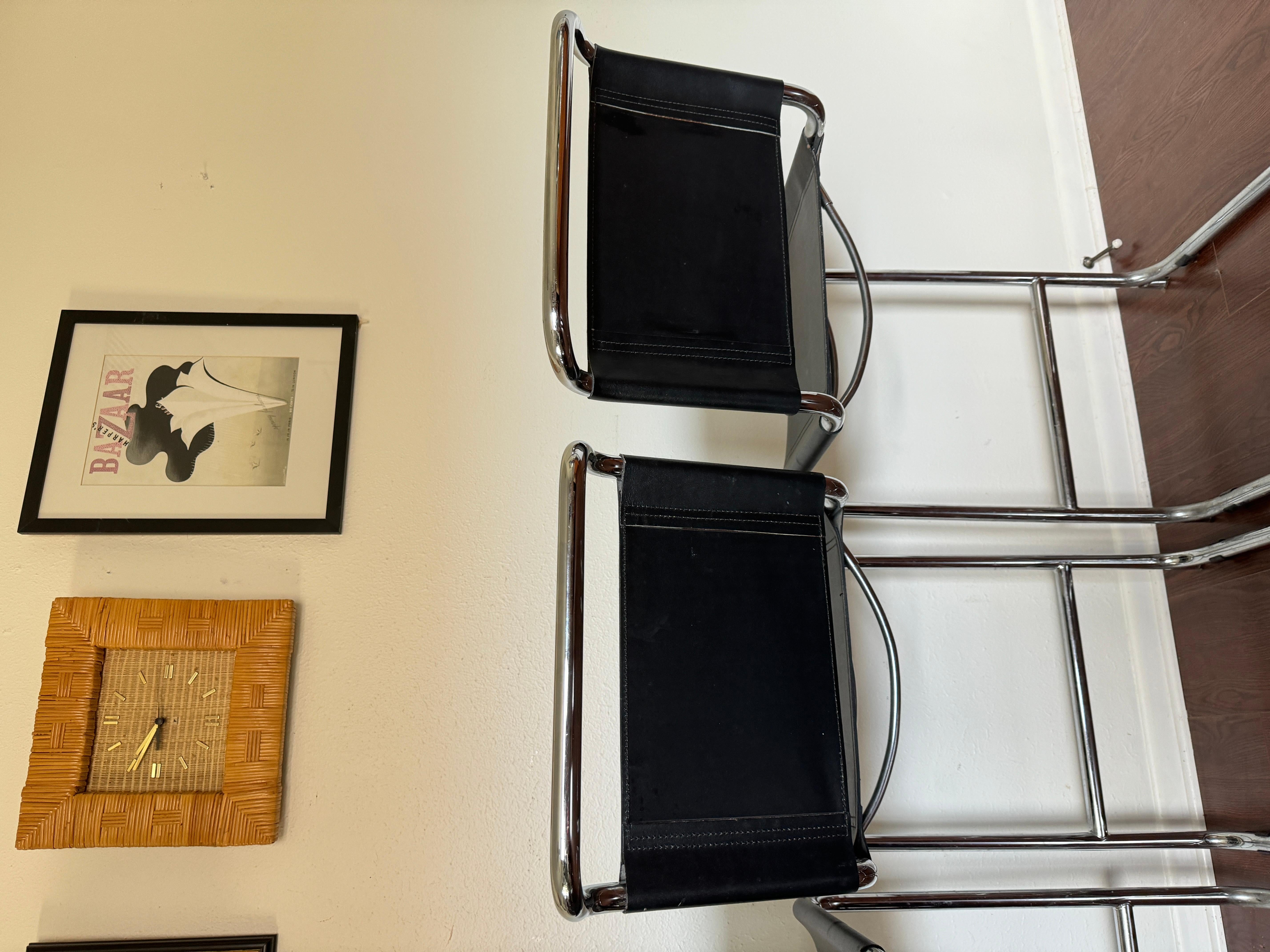 A set of 3 post modern bar stools by Mart Stam, circa 1980s. Chromed tubular steel structure, black leather seat and backrest. There is some minor wear on the leather but no rips or tears and chrome is in good condition. One stool is an inch shorter