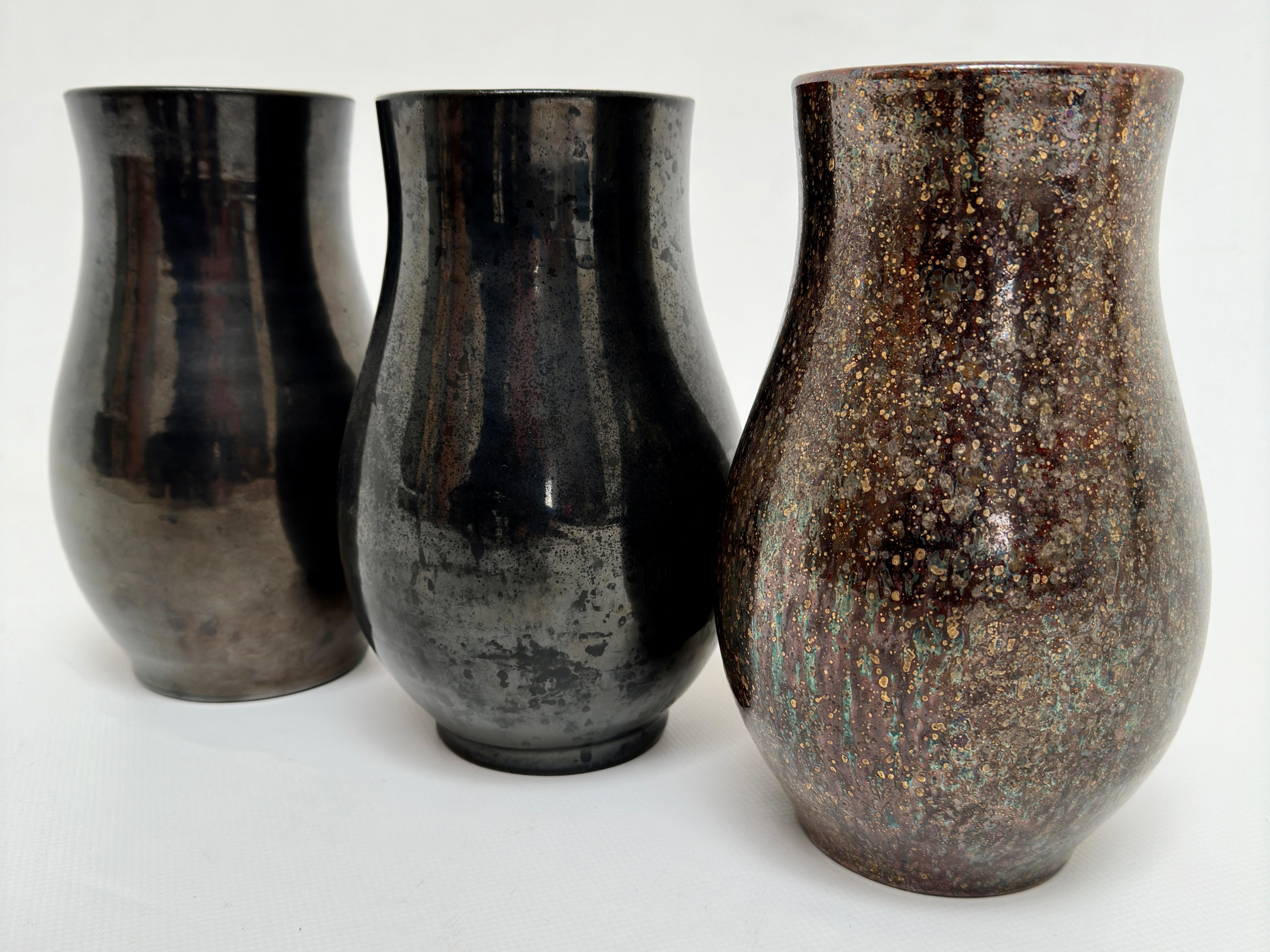 Set of 3 vases with clean lines and metallic glazes.

They are are handcrafted and so, have slight differences in proportions.
They are all in excellent condition and have not been the subject of any restoration.

Each bears the handwritten mention