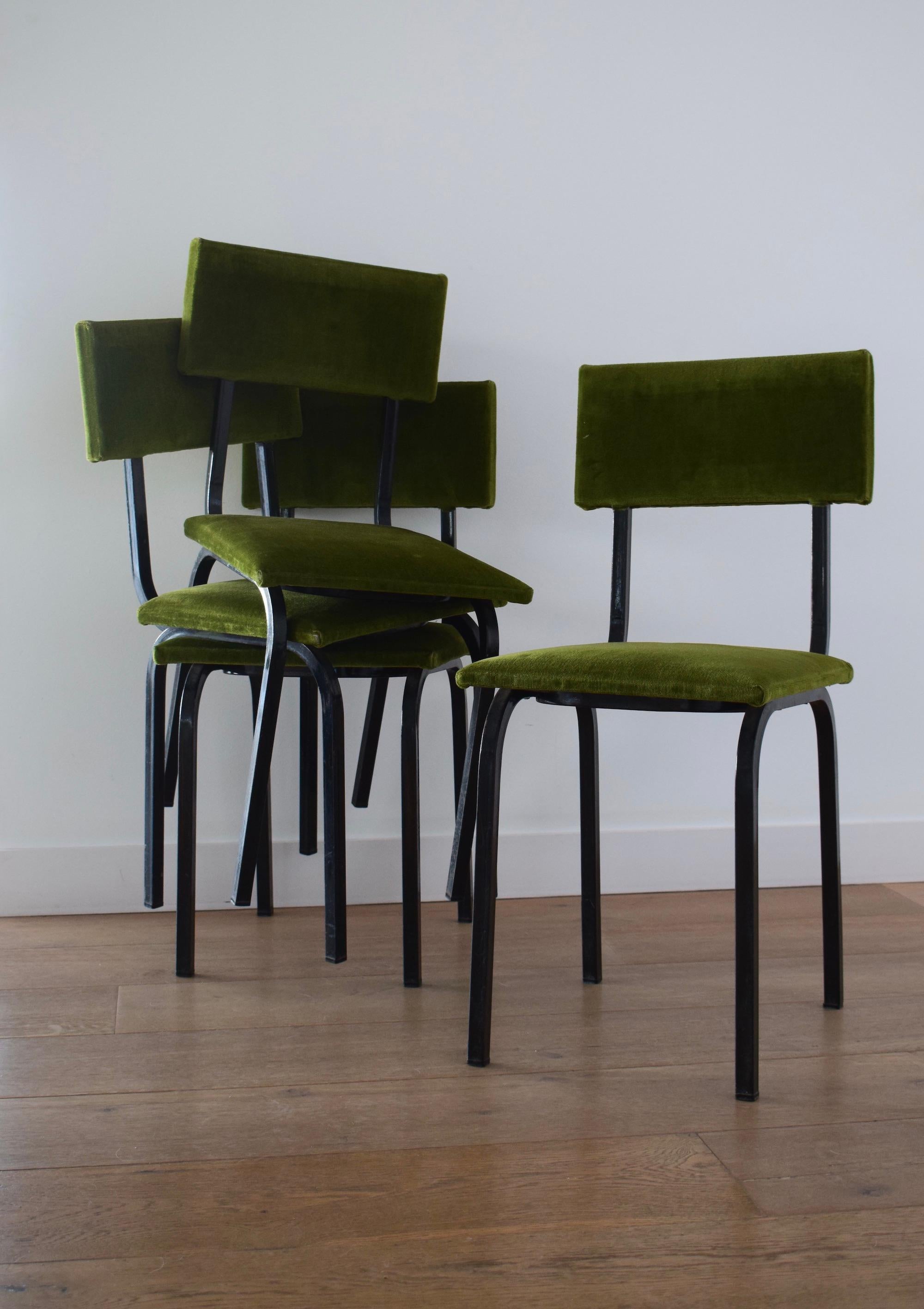 A set of four 1960s retro dining chairs in a vibrant green color. They have a tubular metal black frame with the original upholstery material intact. They are cool pieces! And similar in style to the French furniture designer Andre Simard Airborne