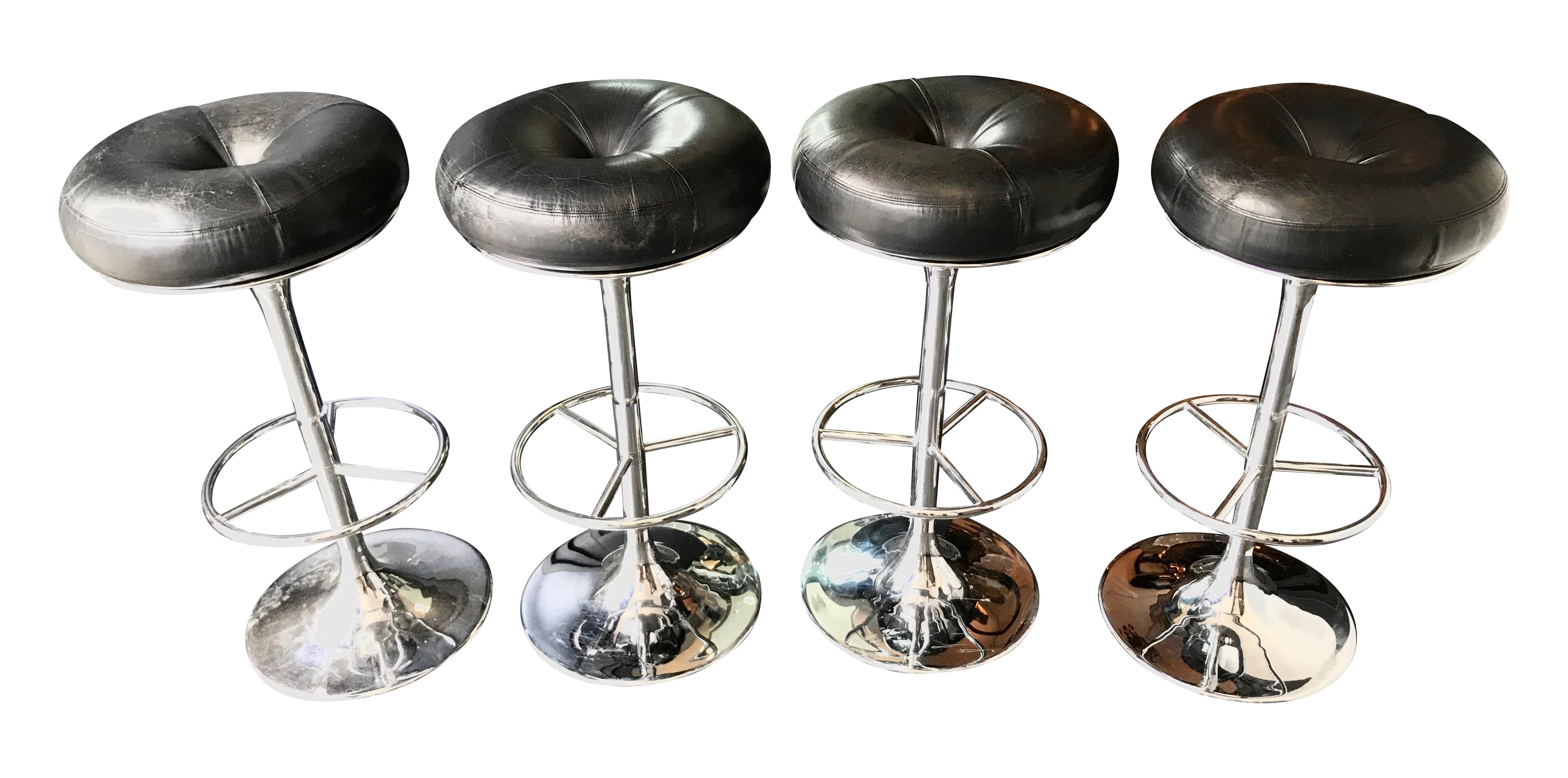 A set of 4 1970s chrome and black leather bar stools by Johanson Design, Sweden each with chrome footrest.