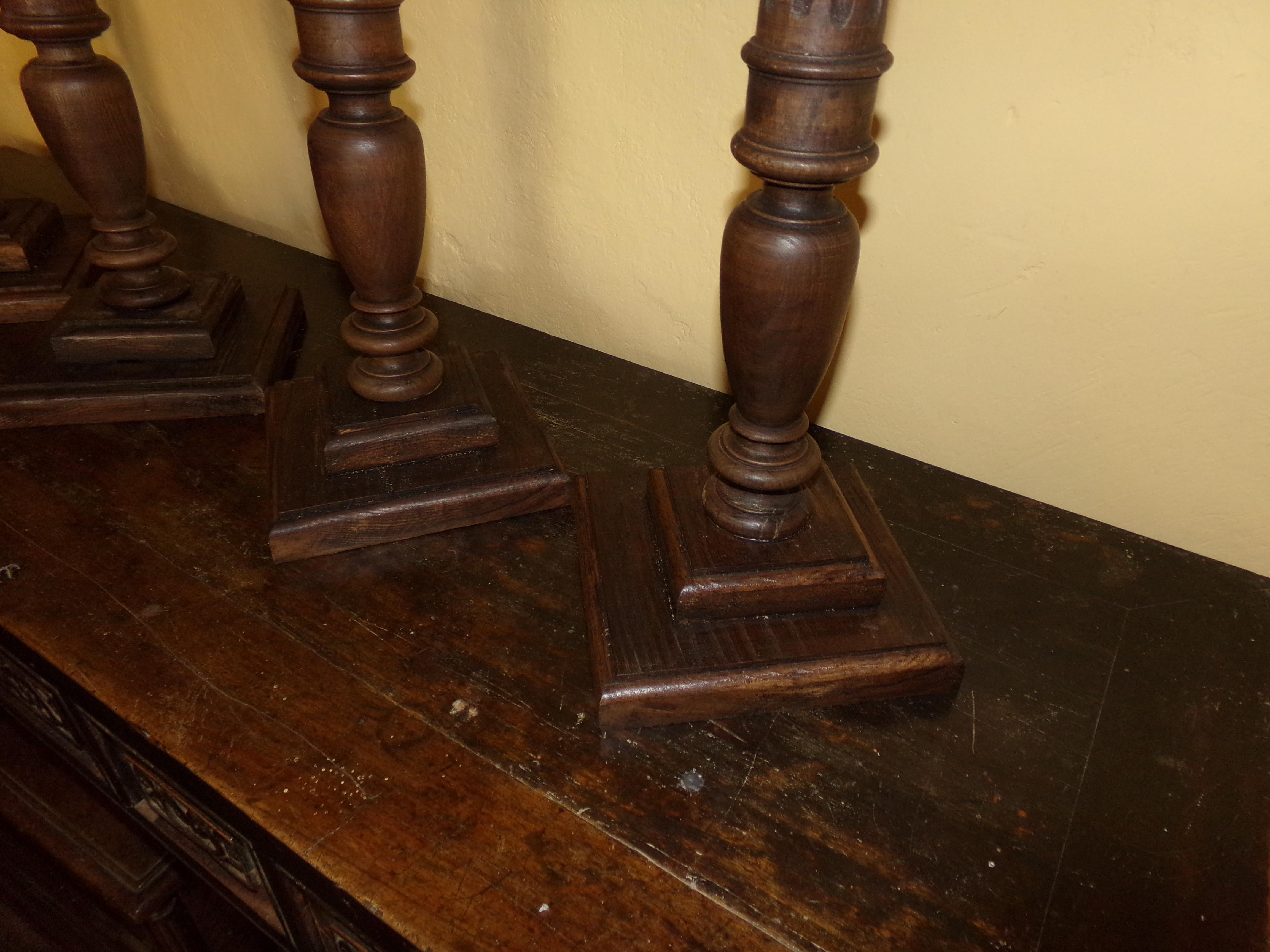 A rare set of four turned, carved and fluted Prickett walnut candlesticks / torchers in the Louis XVI style beautifully crafted from original circa 1890s wood turnings. Our craftsman has retained all the original patination. A beautiful holiday gift