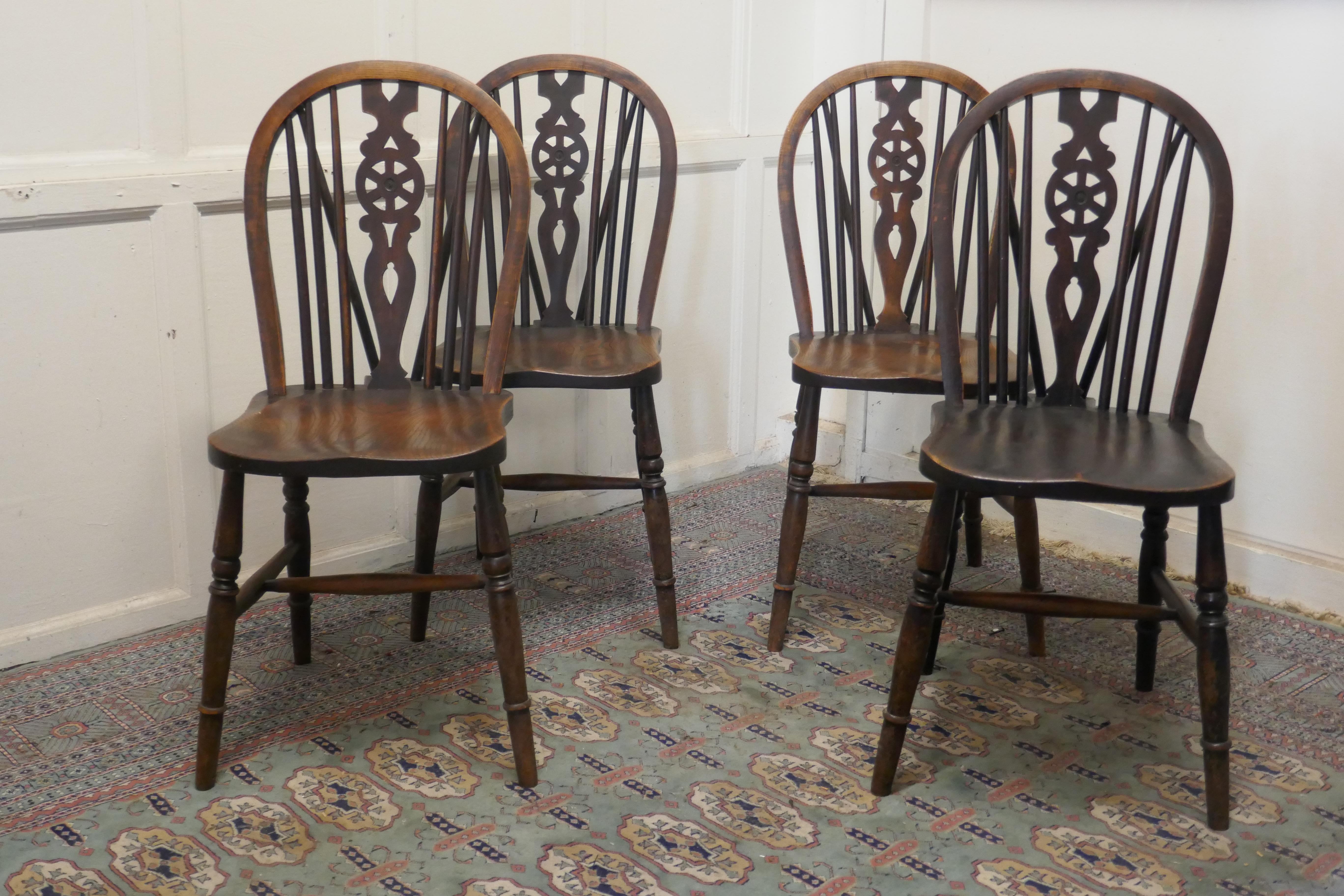 A Set of 4 beech & elm wheel back Windsor kitchen dining chairs


The chairs are a classic design and traditionally made from solid wood they have hooped wedge backs in the traditional Windsor style with spindles and a pierced centre splat in the