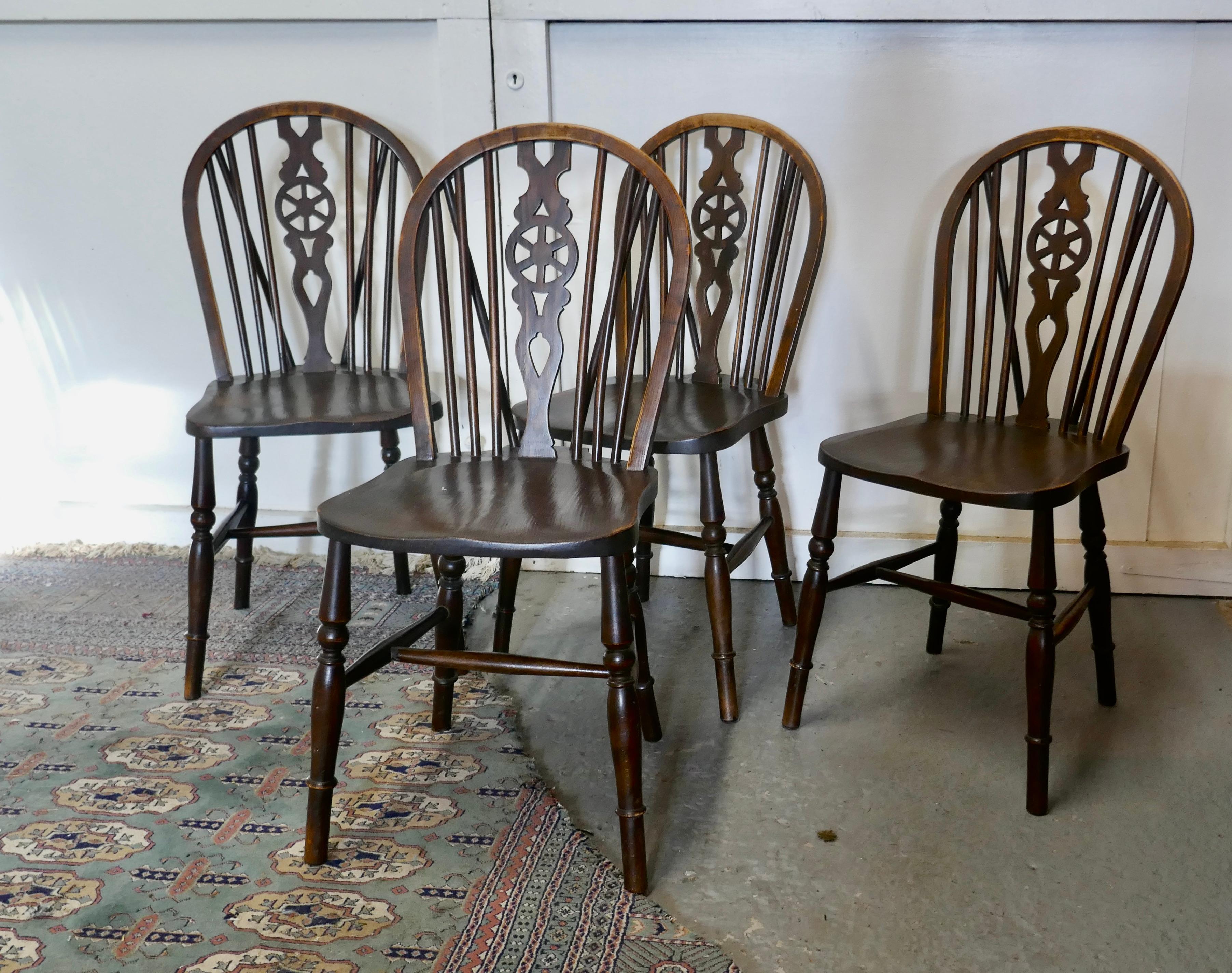 A Set of 4 Beech & Elm Wheel Back Windsor Kitchen Dining Chairs


The chairs are a classic design and traditionally made from solid wood they have hooped wedge backs in the traditional Windsor style with spindles and a pierced centre splat in the