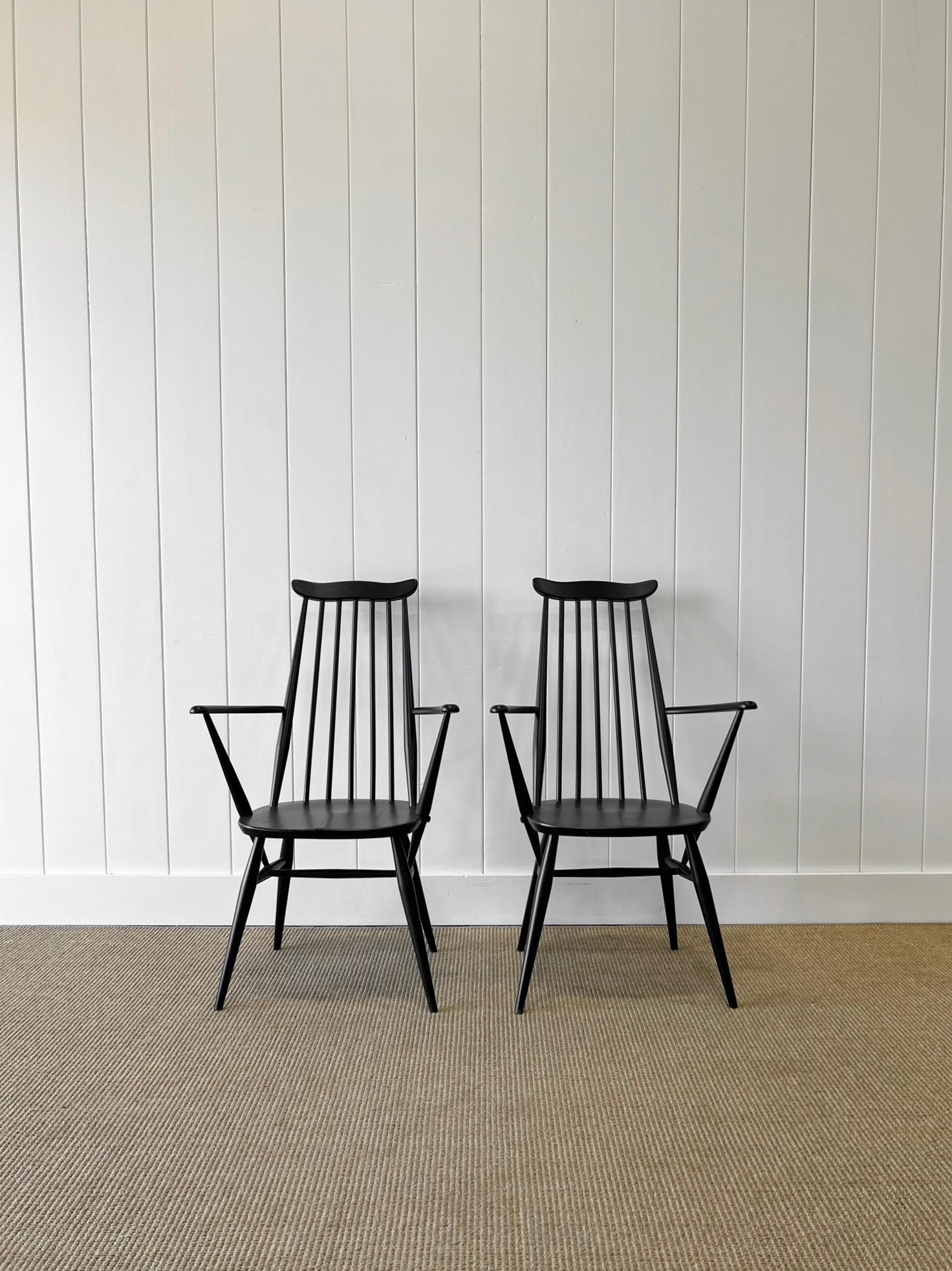 A good set of vintage English Ercol chairs painted black. Very solidly built in the traditional way.  Two armchairs and two side chairs with handsome profiles, good and heavy.  Perfect around a farmhouse table! Solid in joint. These are not
