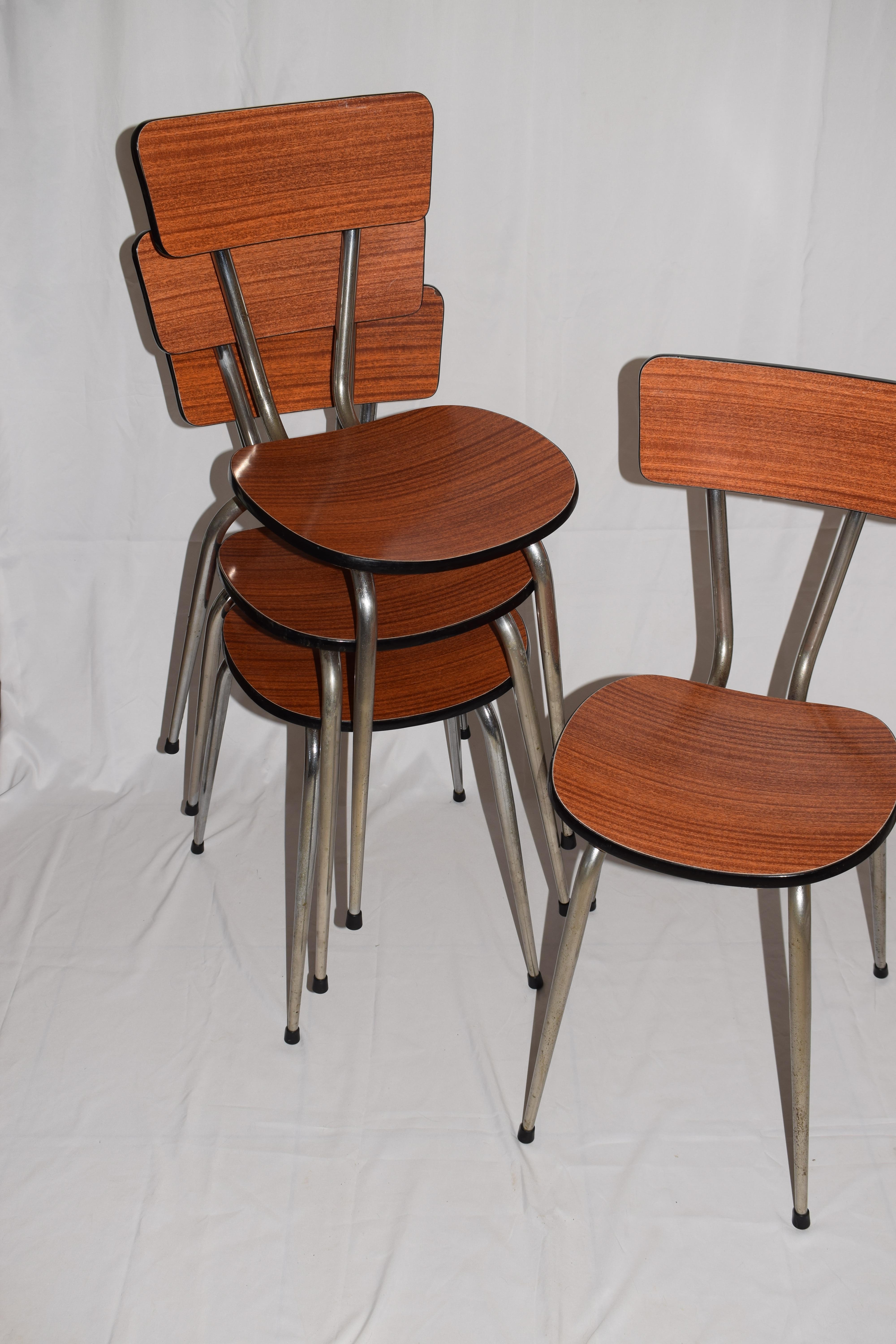 A set of four French Formica respoal dining chairs with chrome metal frames. From the 1960s they are iconic furniture from this age. The chrome legs are tapered. A retro piece of design - would look great in any home. All chairs are in a good