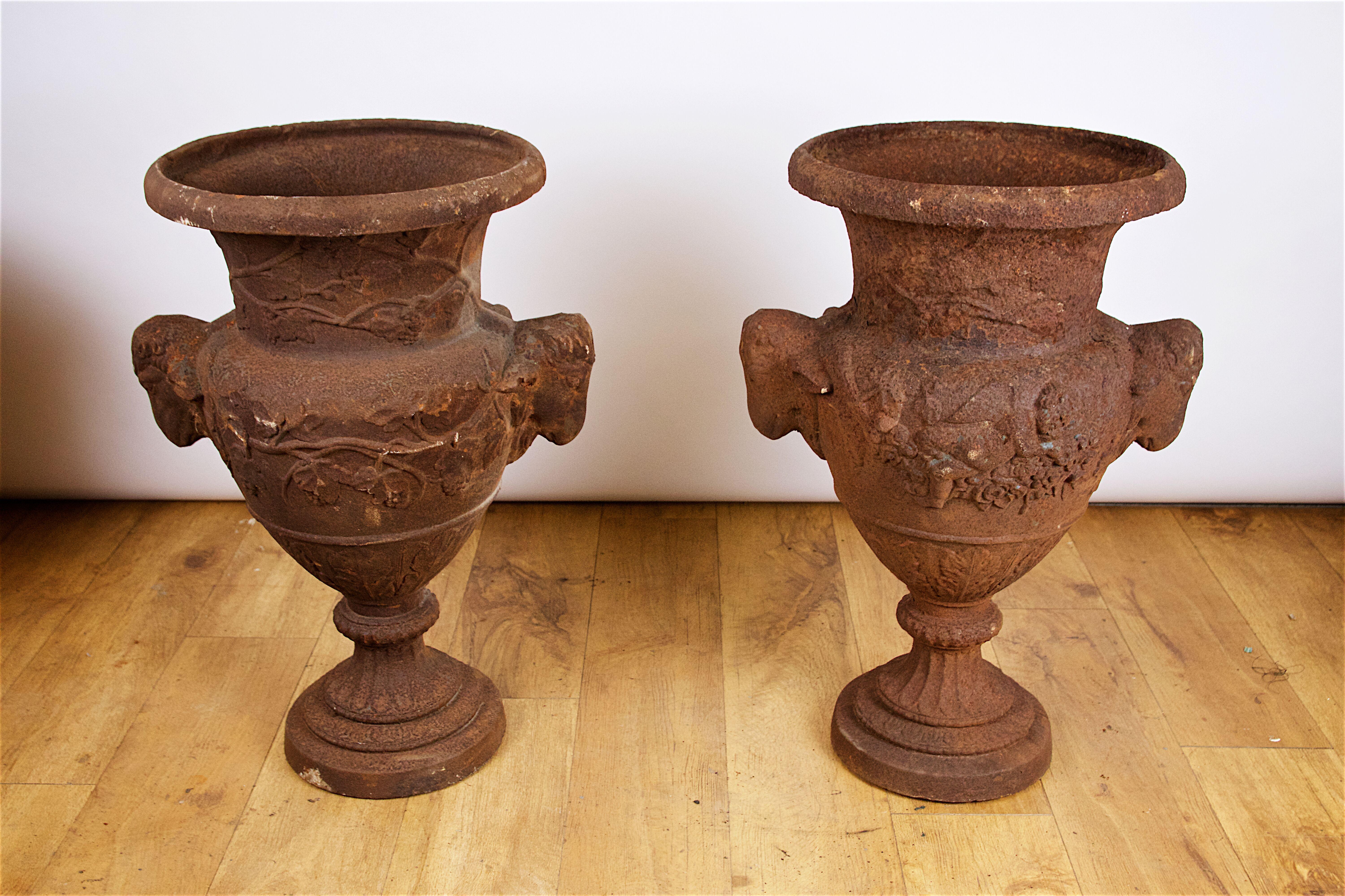 A set of 4 cast iron garden urns, after the antique, 20th century.
