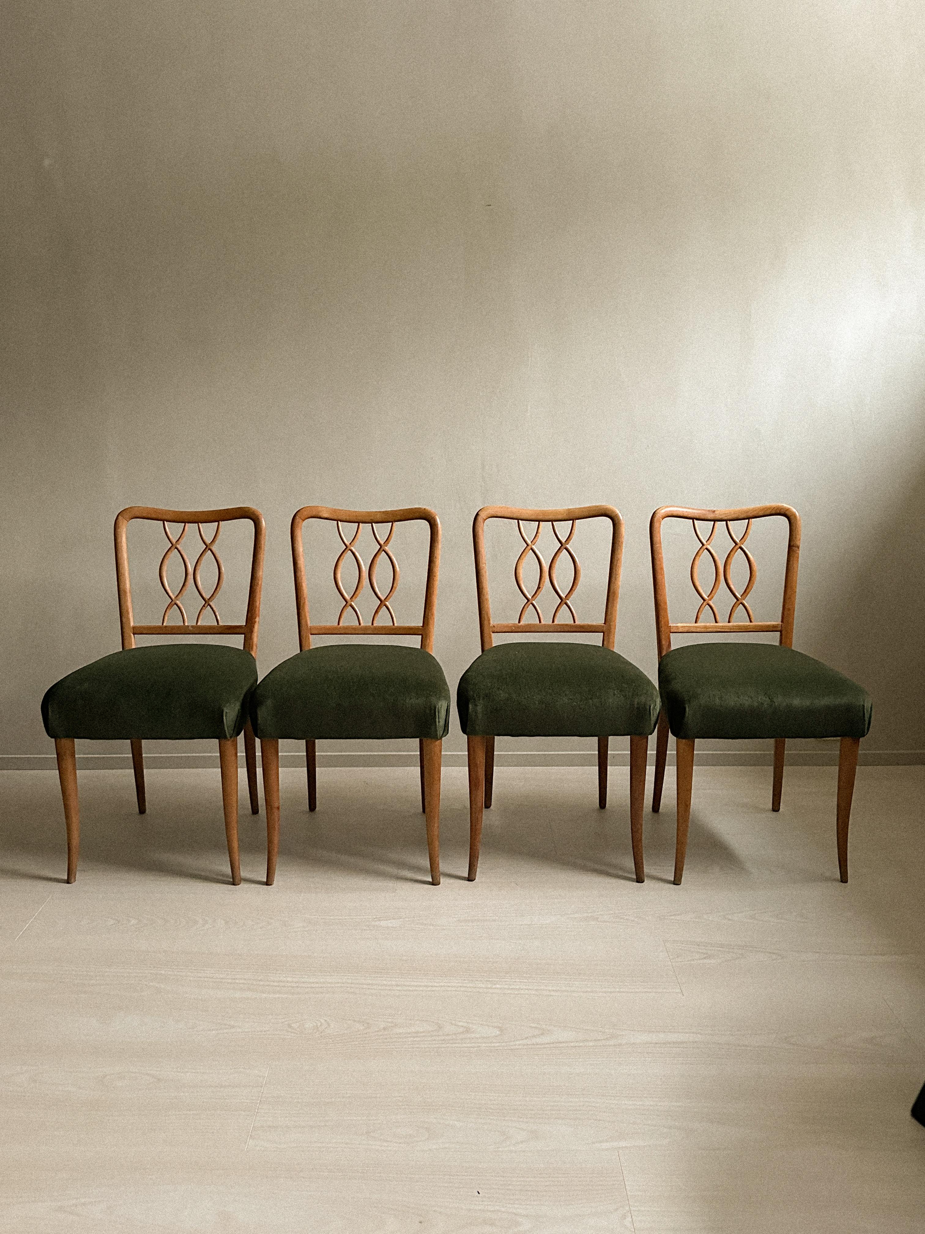 A wonderful set of 4 dining room chairs. Produced in France during the 1960s, these chairs has been reupholstered in a green velvet. Wood is kept in its original condition showing beautiful patina. 

Wear consistent with age and use.  