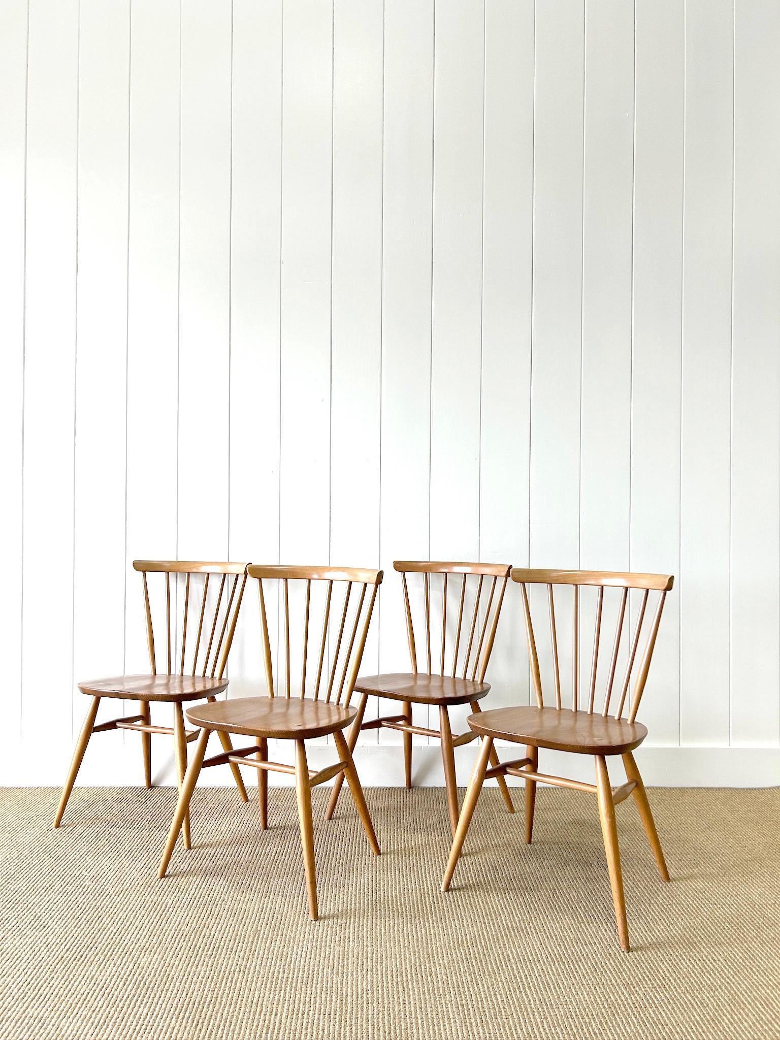 A good set of vintage ash stick back side chairs. Very solidly built in the traditional way.  Handsome retro profiles.  Perfect around a farmhouse table! Solid in joint. These are not antiques, but built the traditional way in England by Ercol,
