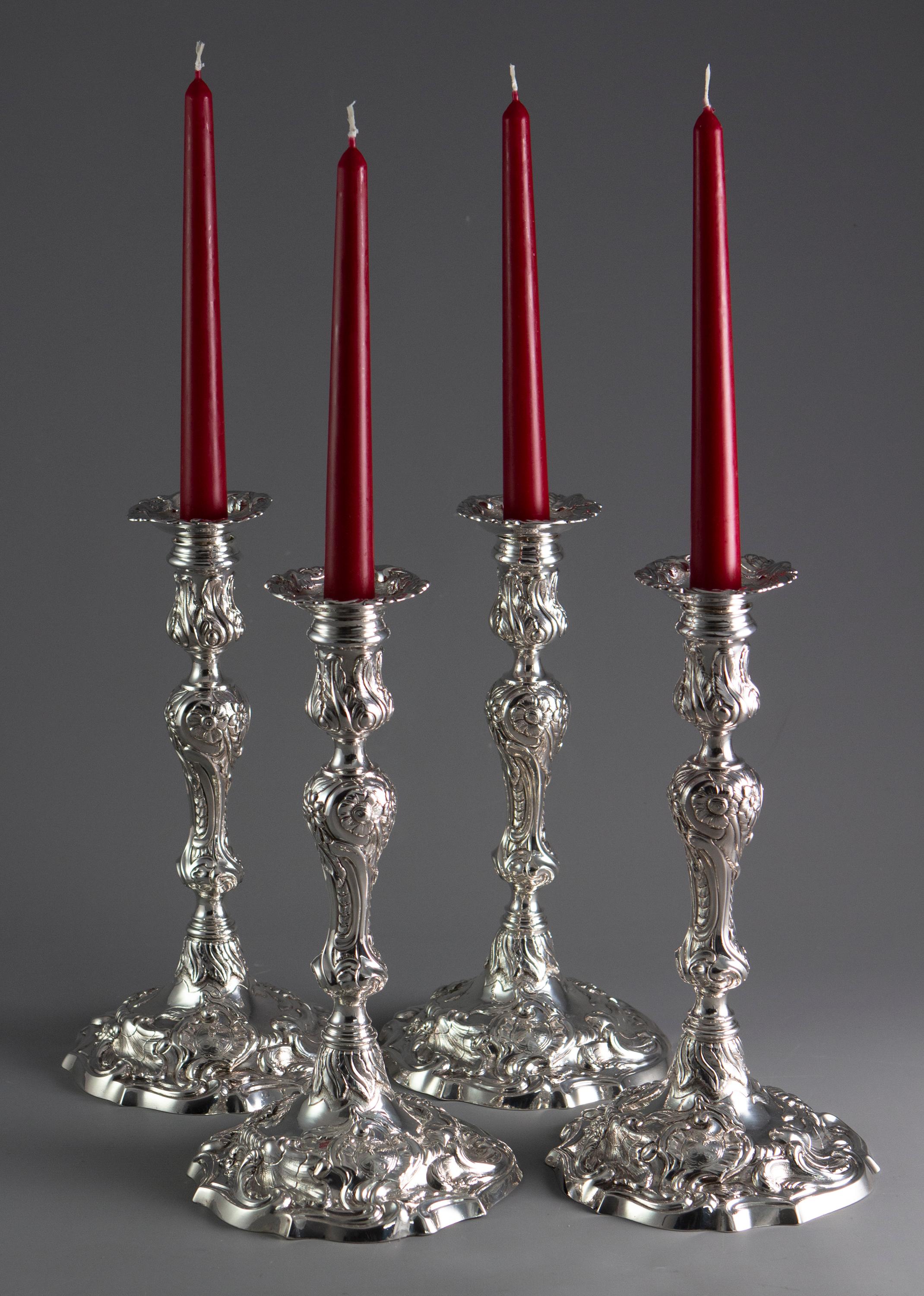 An extremely fine set of cast silver George II table candlesticks in the naturalistic style. Standing on a cast, shaped base, the fluted and knopped column is surmounted with to a shaped capital. All decorated in the asymmetrical naturalistic style