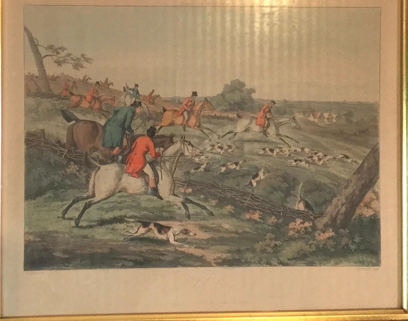 A handsome set of four English hand colored engraved prints in antique medium wood color frames. The set is of English fox hunting scenes from the early 19th century. Dimensions: 17.5