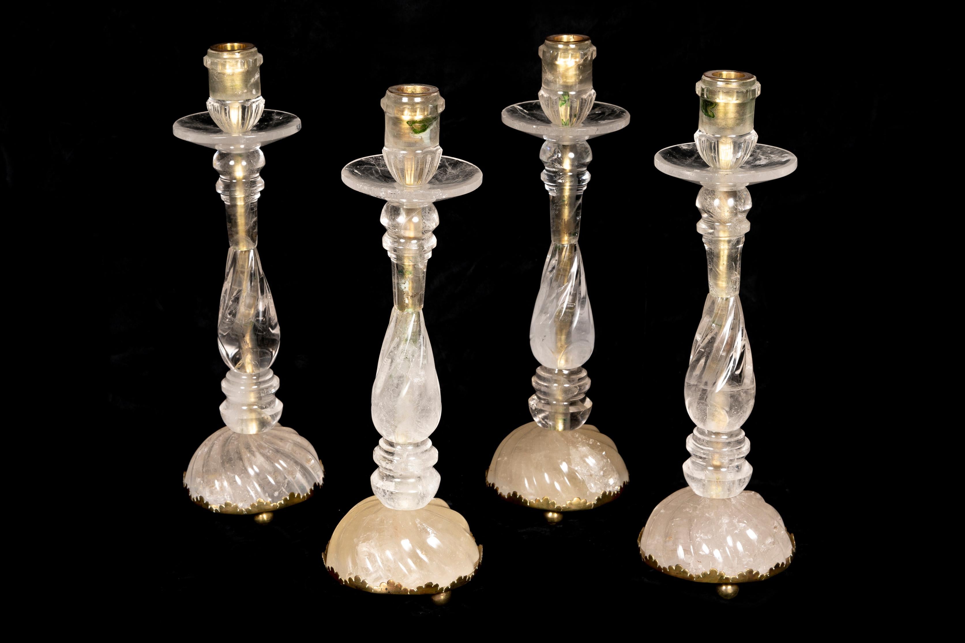 A Set of 4 Large Louis XVI Style Bronze mounted Cut rock crystal candlesticks of fine detail on circular rock crystal bases.