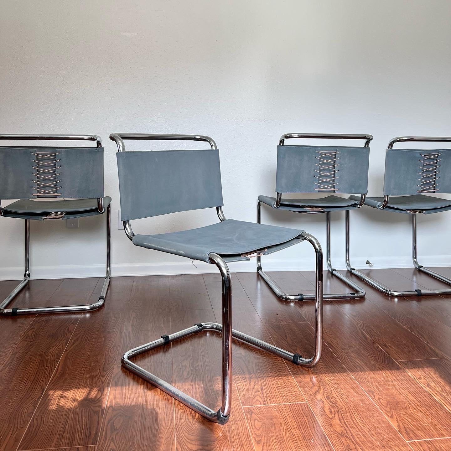 A set of 4 Marcel Breuer B33 dining chairs by Gavina from the 1950s. Upholstered in the original canvas gray fabric and the backs are held together by laces which are in great condition. Chrome has normal wear for age, and one chair has a bit more