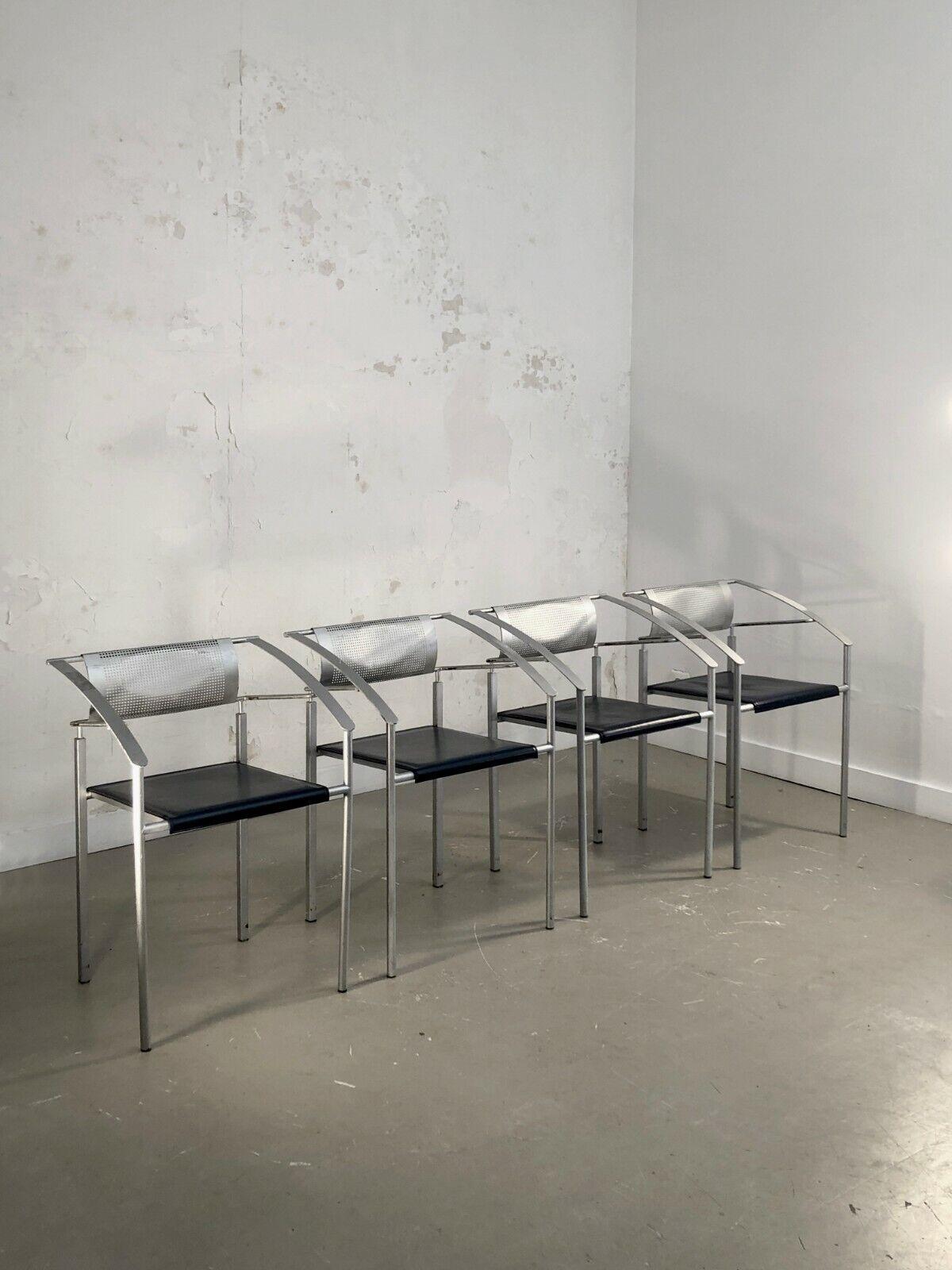 A set of 4 stackable chairs, Post-Modernist, Constructivist, Memphis, complex geometric structures in metallic gray square section metal, seats in dark blue leather, backrest and perforated metal, Fly-Line edition, Italy 1980-1990.

DIMENSIONS: H 75