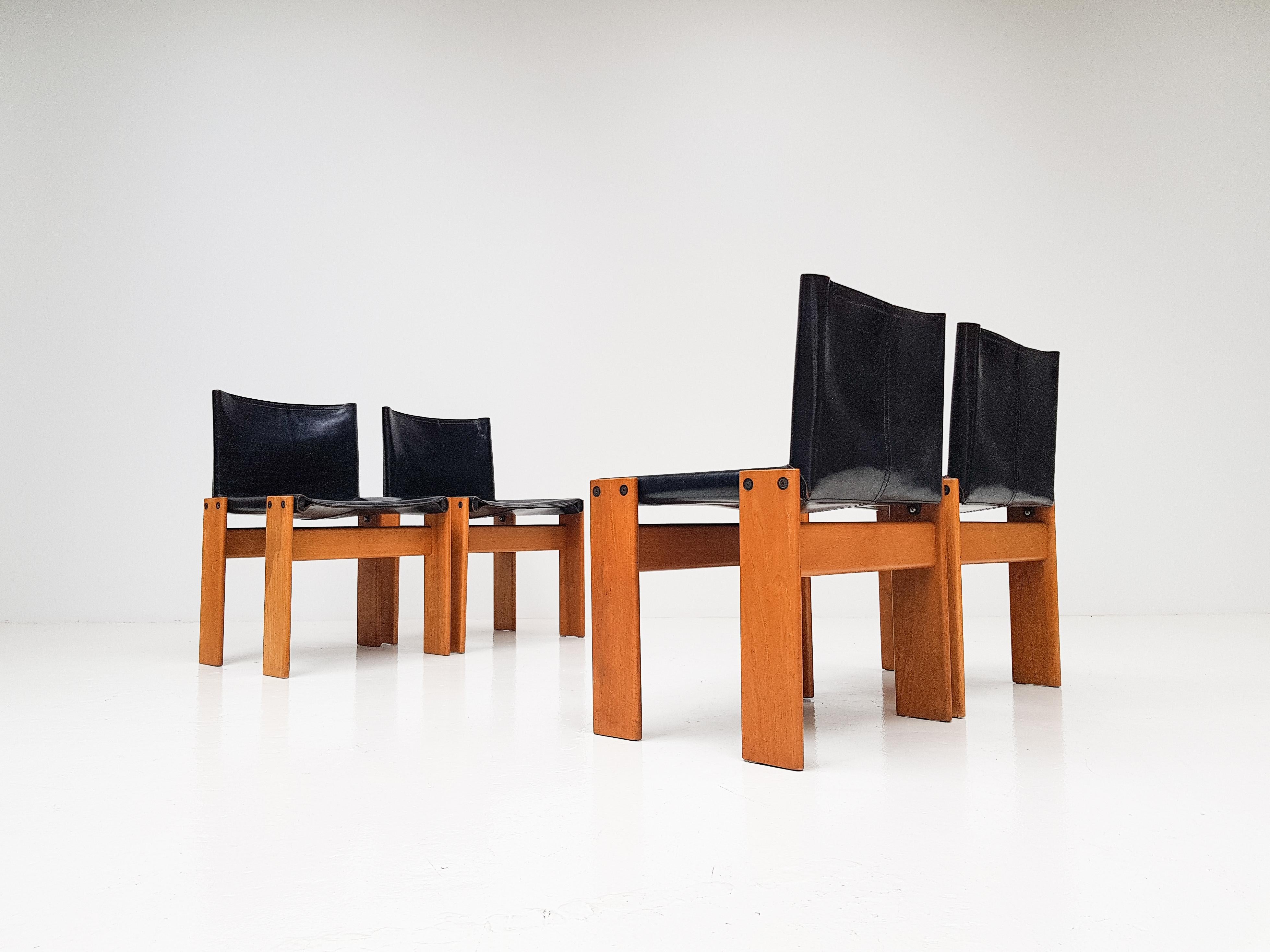 A set of 'Monk' dining chairs by Italian award-winning designer couple Afra & Tobia Scarpa. 

Patinated beech and thick black saddle leather the design is high-quality, minimal and solid. Manufactured by Molteni, Italy, 1974. 

A stunning set.

We
