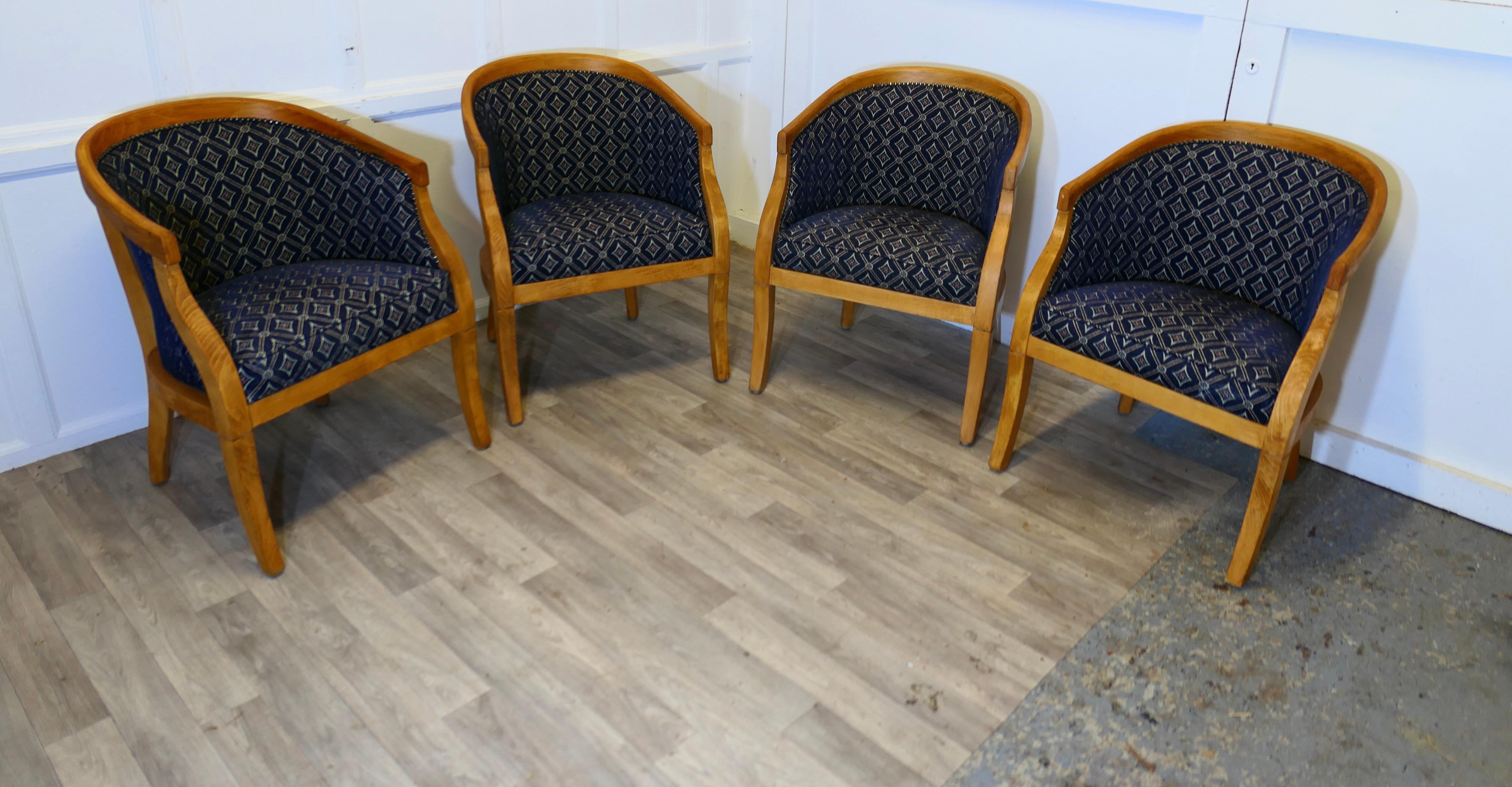 A Set of 4 Upholstered Tub Chairs

This wonderful set has rounded backs and sturdy golden oak frames, they have an attractive curved shape and are upholstered in an uncut moquette, dark blue with a diamond design
The chairs are in good used
