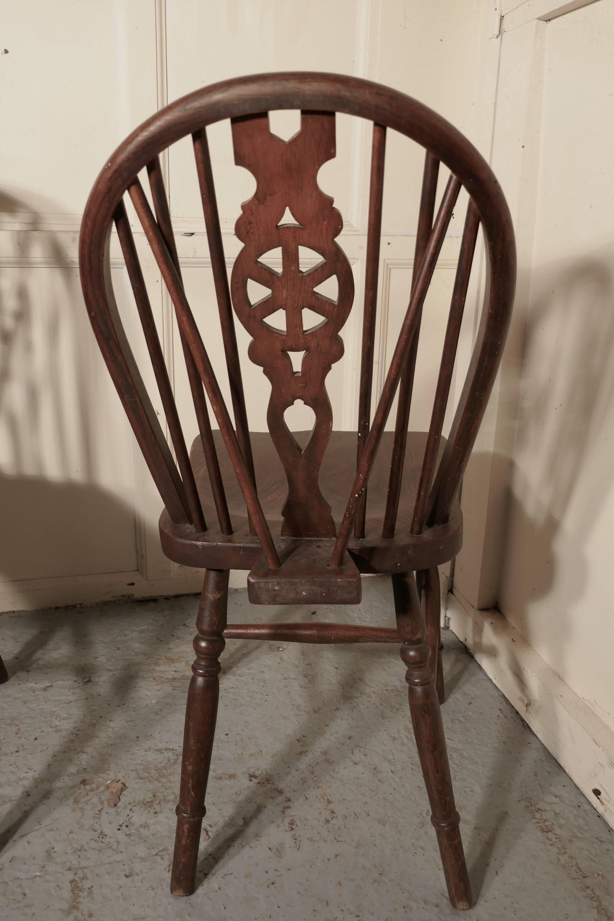 A set of four Victorian beech and elm wheel back Windsor kitchen dining chairs


The chairs are a classic design and traditionally made from solid wood they have hooped wedge backs in the traditional Windsor style with spindles and a pierced