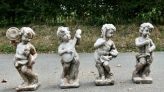 A Set of 4 Weather Worn Cherub Statues with Instruments  This is a wonderful set