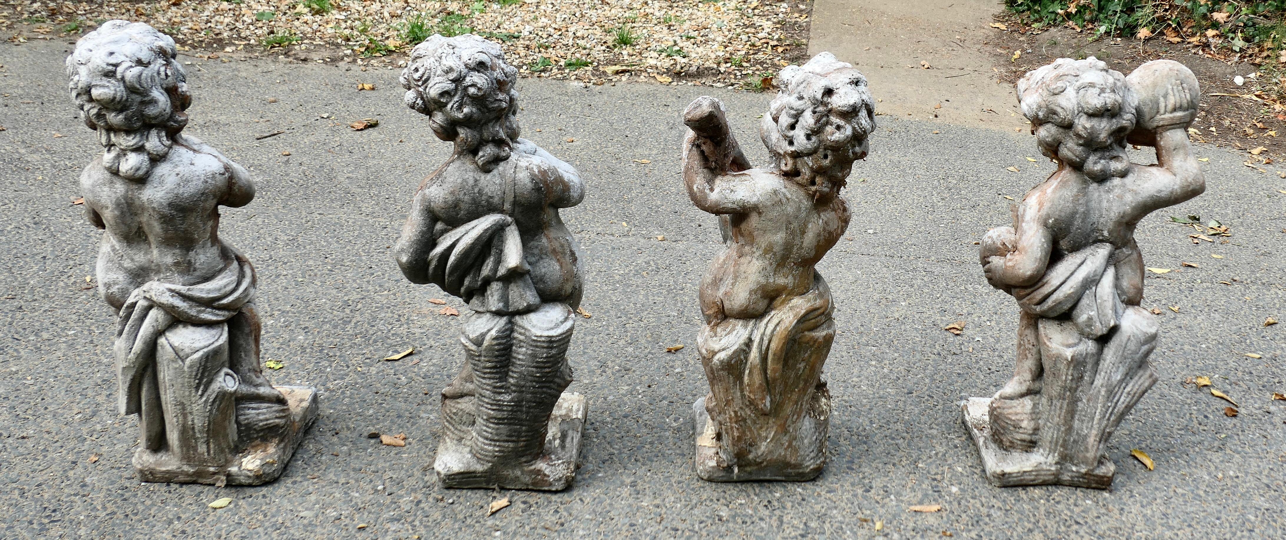 A Set of 4 Weather Worn Cherub Statues with Instruments  This is a wonderful set For Sale 1