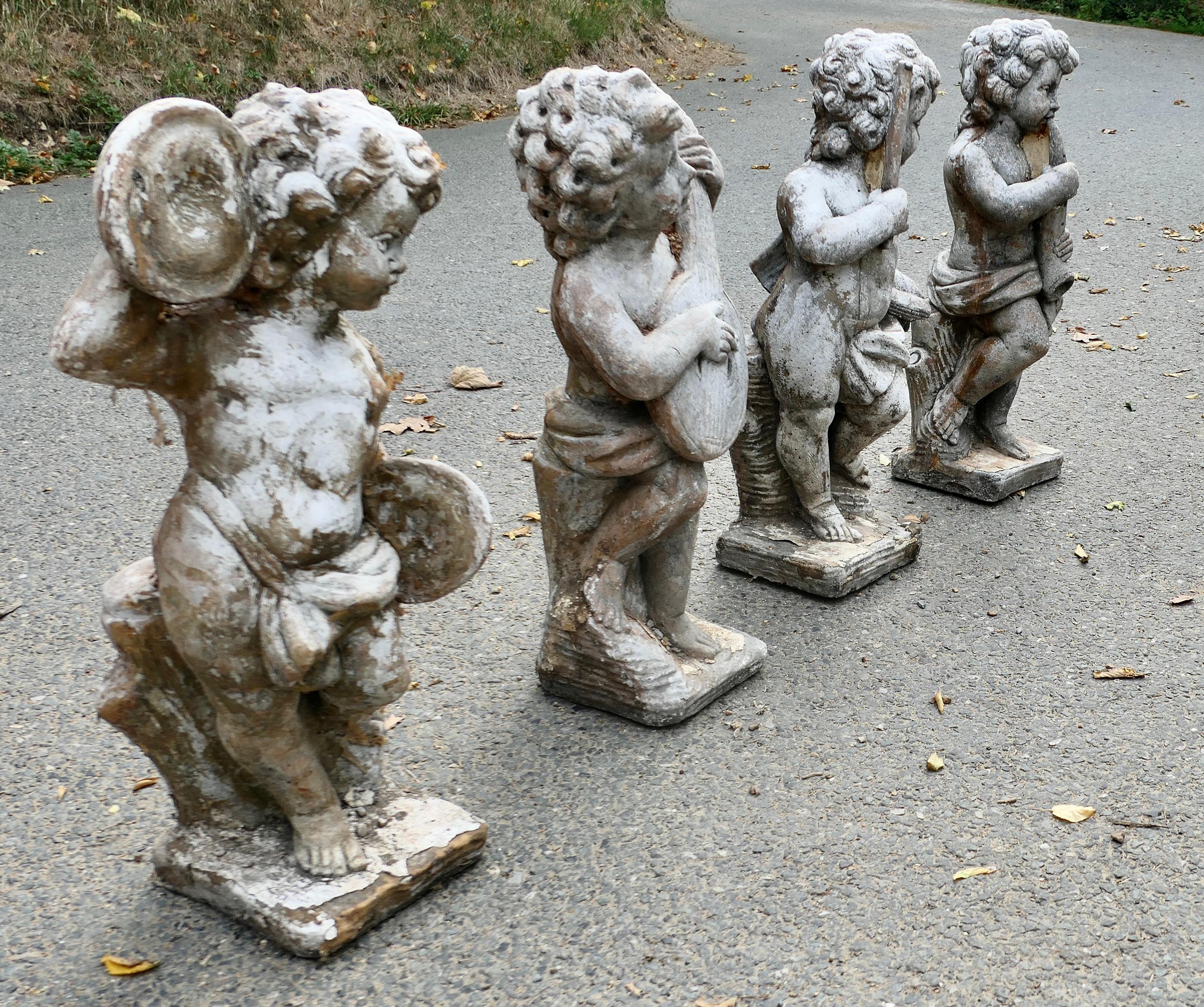 A Set of 4 Weather Worn Cherub Statues with Instruments  This is a wonderful set For Sale 2