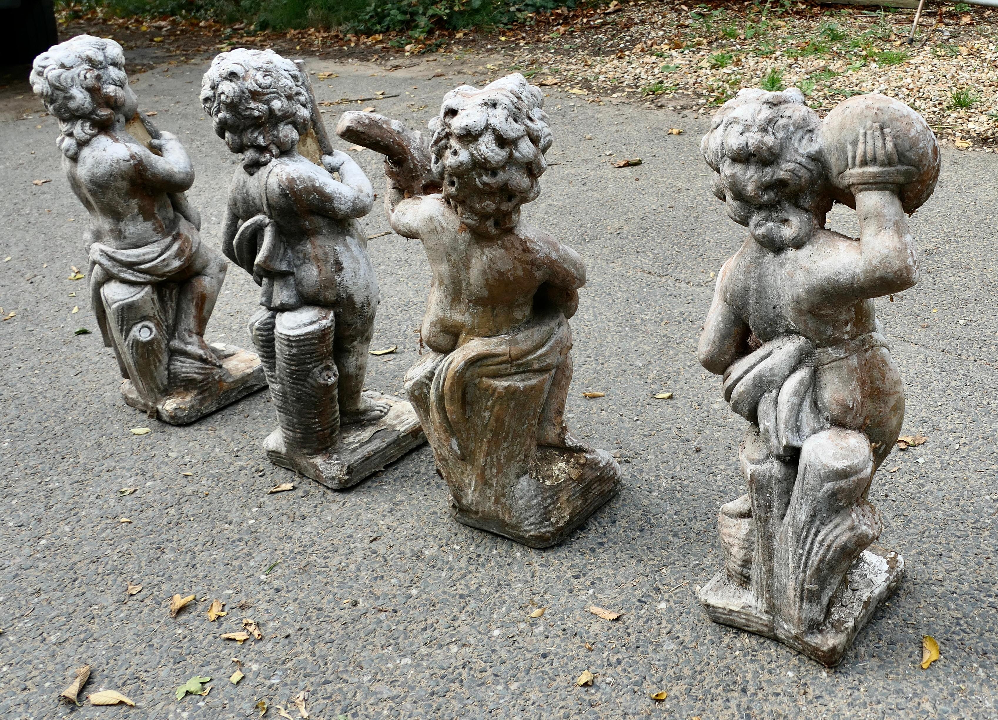 A Set of 4 Weather Worn Cherub Statues with Instruments  This is a wonderful set For Sale 3