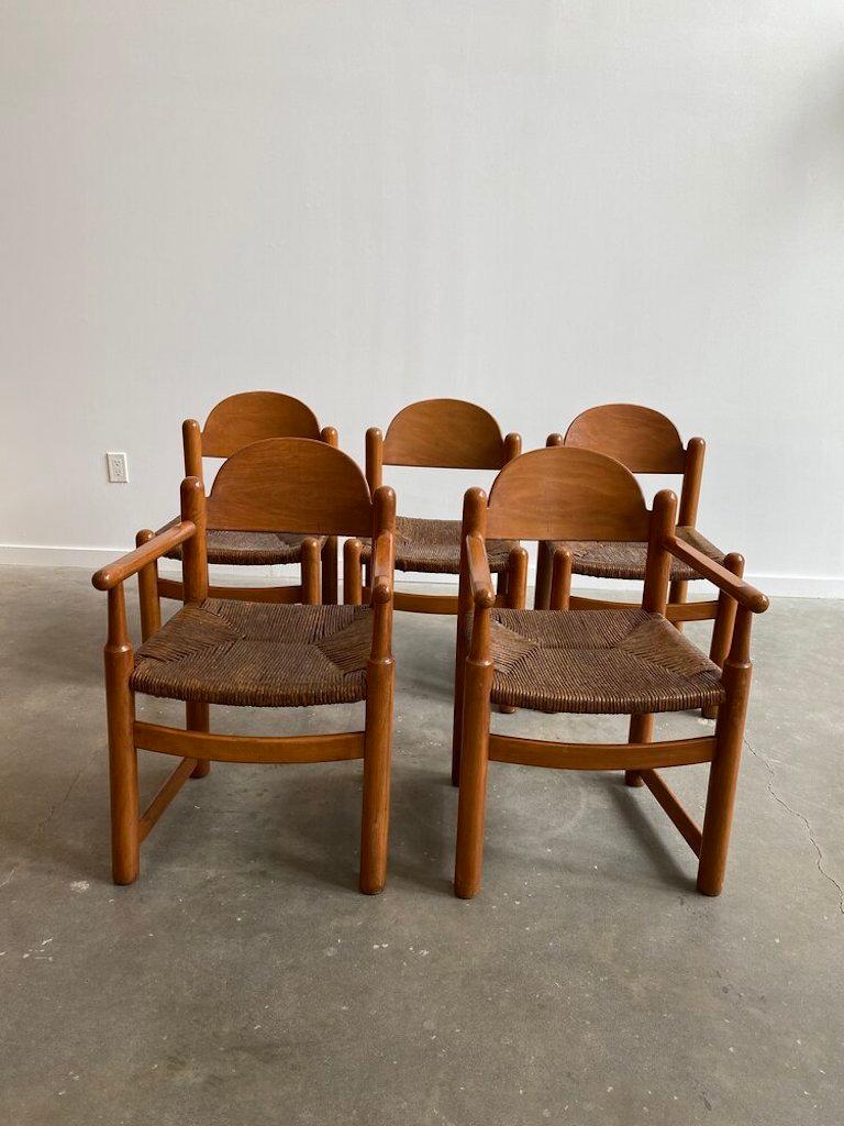 A set of 5 Hank Lowenstein’s “Padova” dining chairs in cherry wood with brown rush seats. Beautiful rounded edges, rush seats are in excellent condition. Made in Italy.