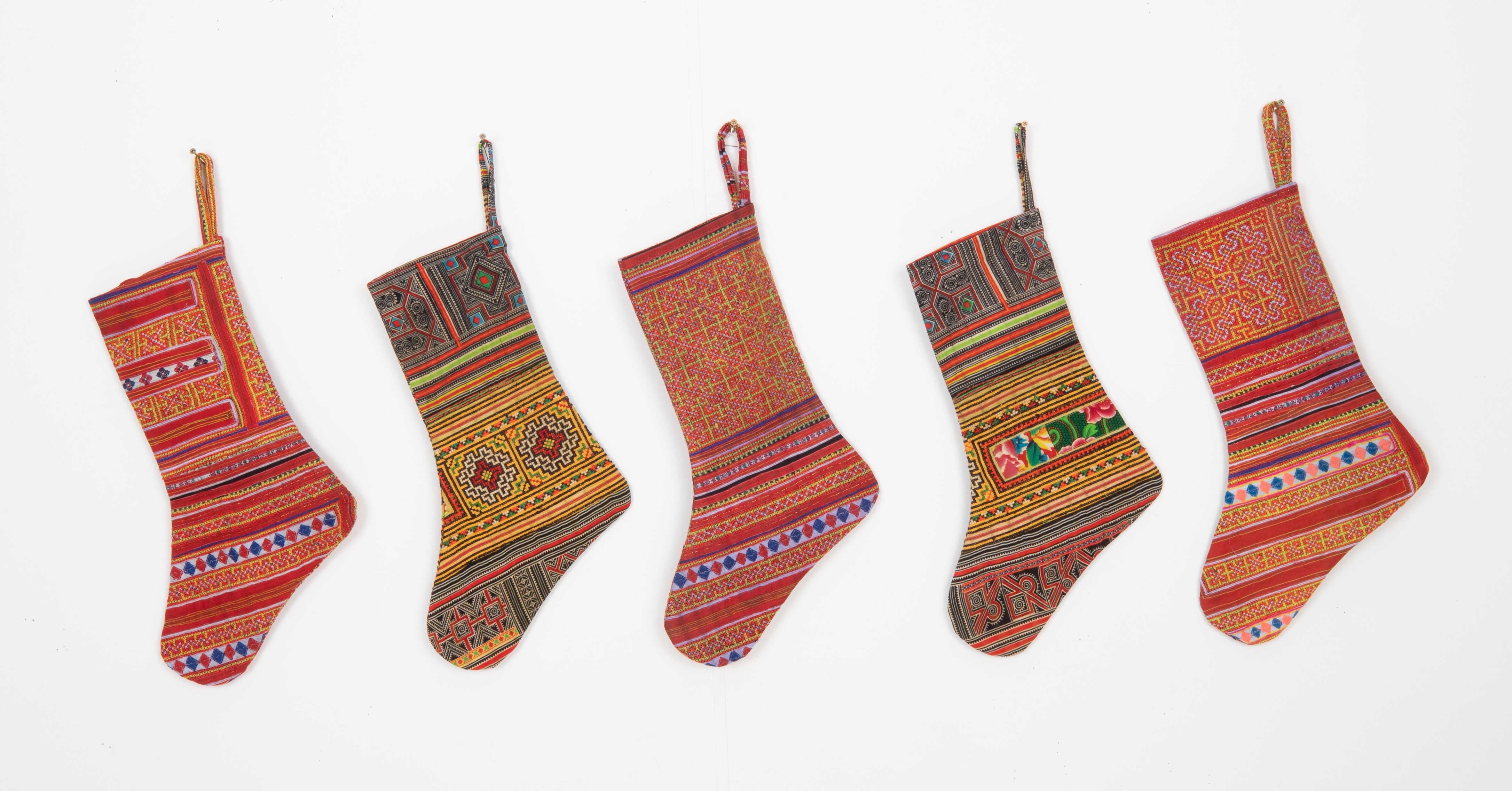 This Christmas Stocking was made from a late 19th or Early 20th C. Hmong textile fragments.
Linen in the back.

Please note, this stocking was made fromHmong textile fragments.
