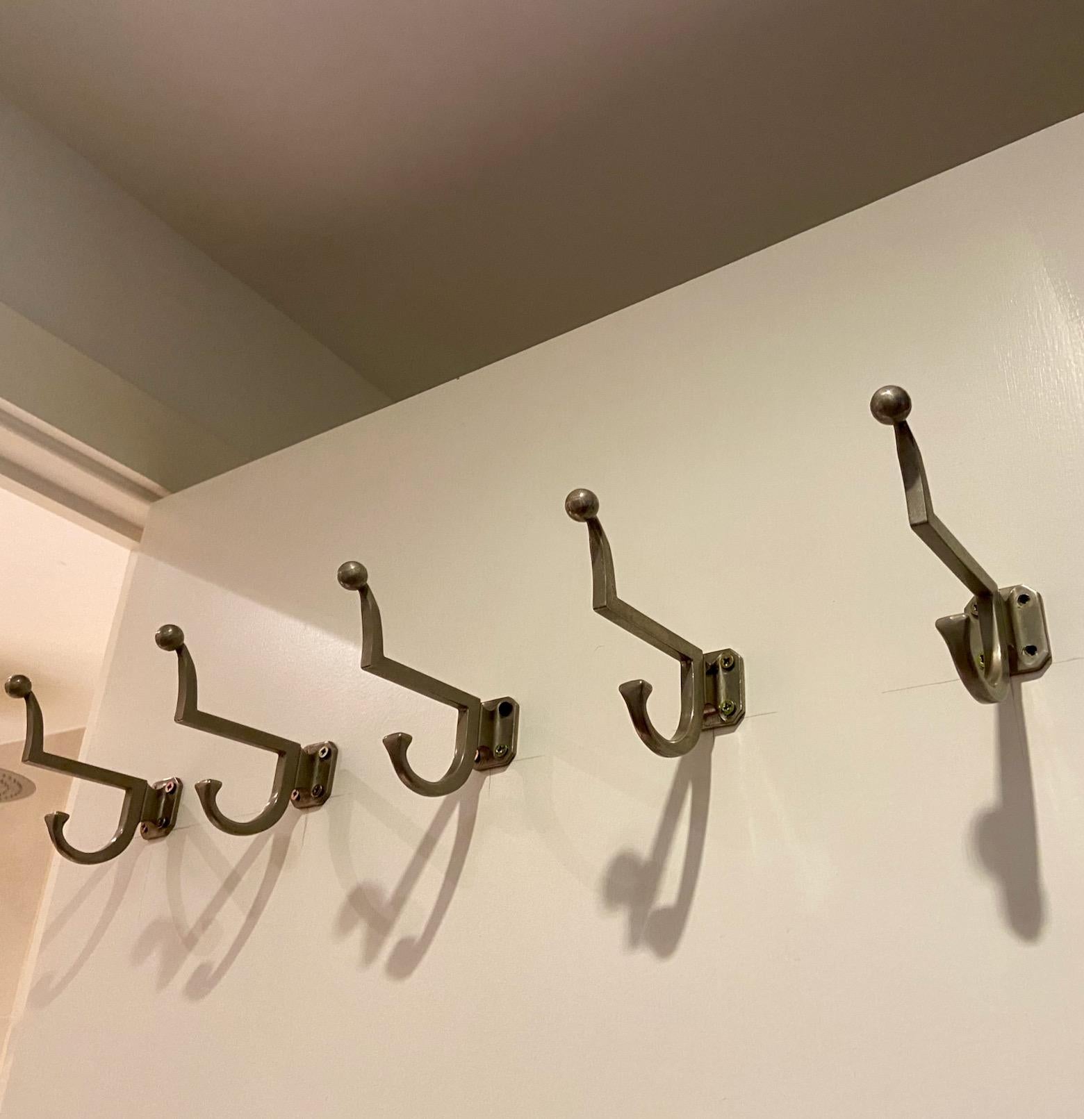 a set of 5 metal coat hooks or hangers, most probably French,  modernist art deco