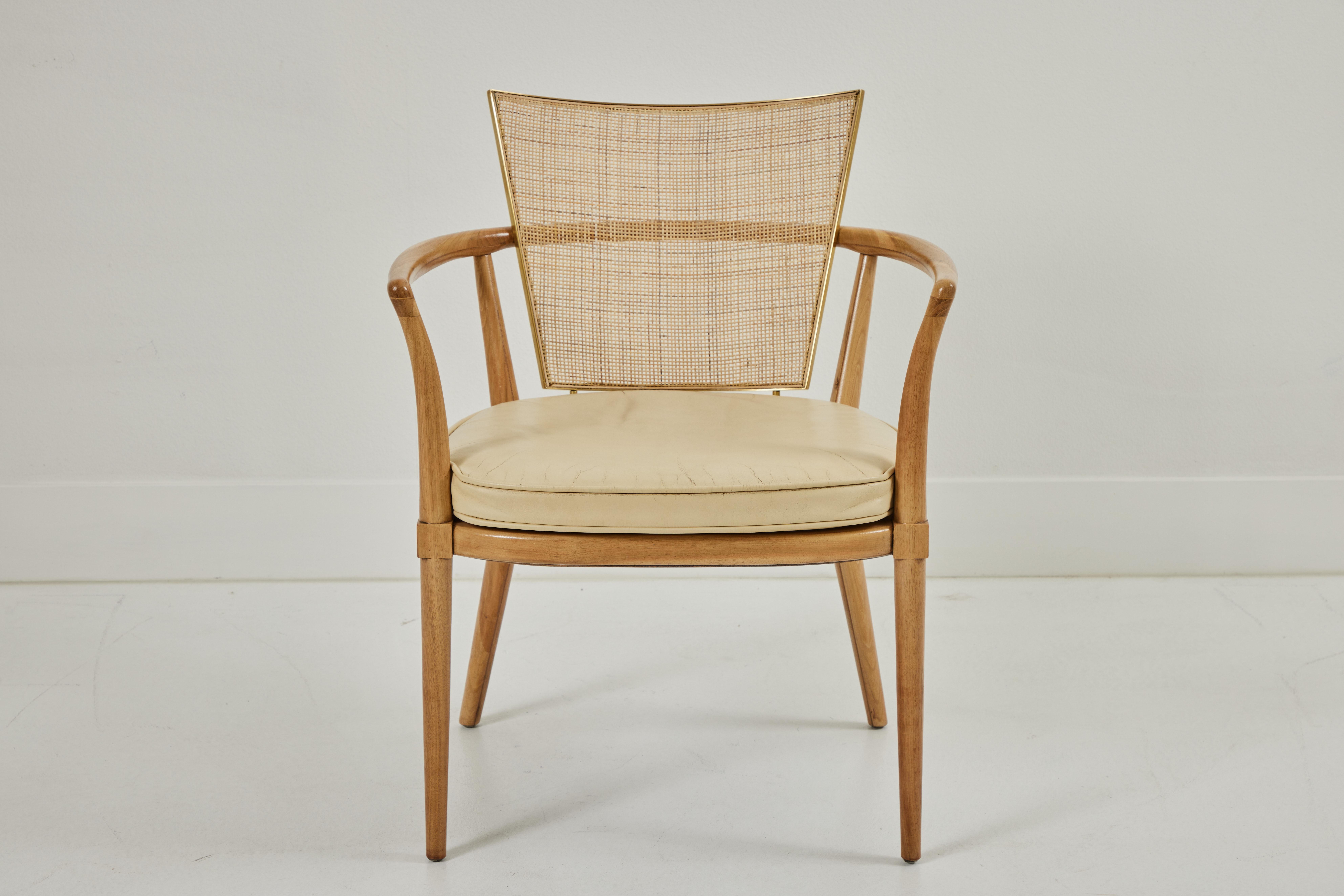 These dining chairs are bleached walnut with newly restored cane set within a brass framework. The cushions and leather upholstery are original, with a lovely patina and do reflect some age, adding to the vintage character of the chairs. The dining