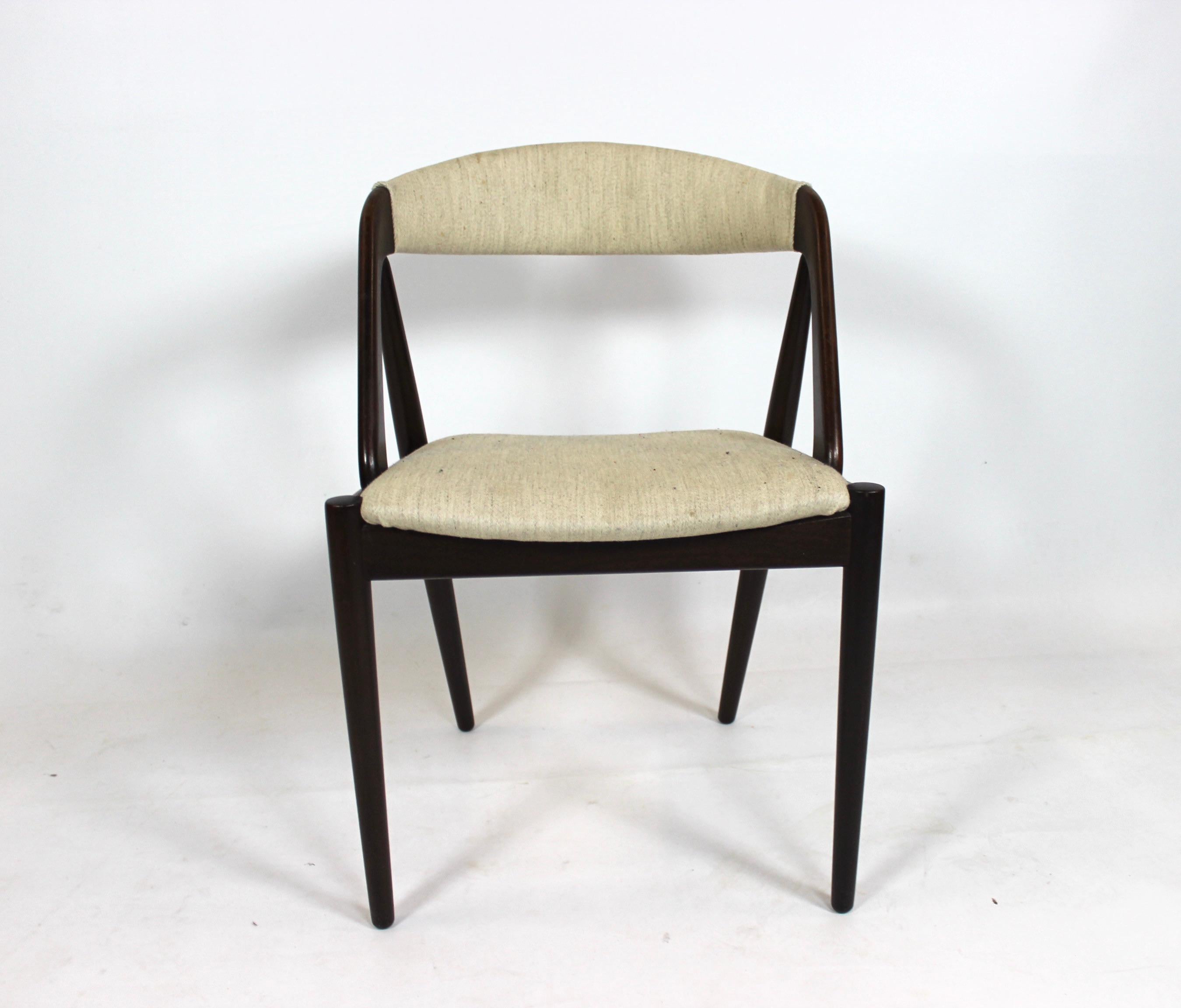 A set of six dining chairs, model 31, designed by Kai Kristiansen and manufactured by Schou Andersen in the 1960s. The chairs are of teak and upholstered with light fabric.
