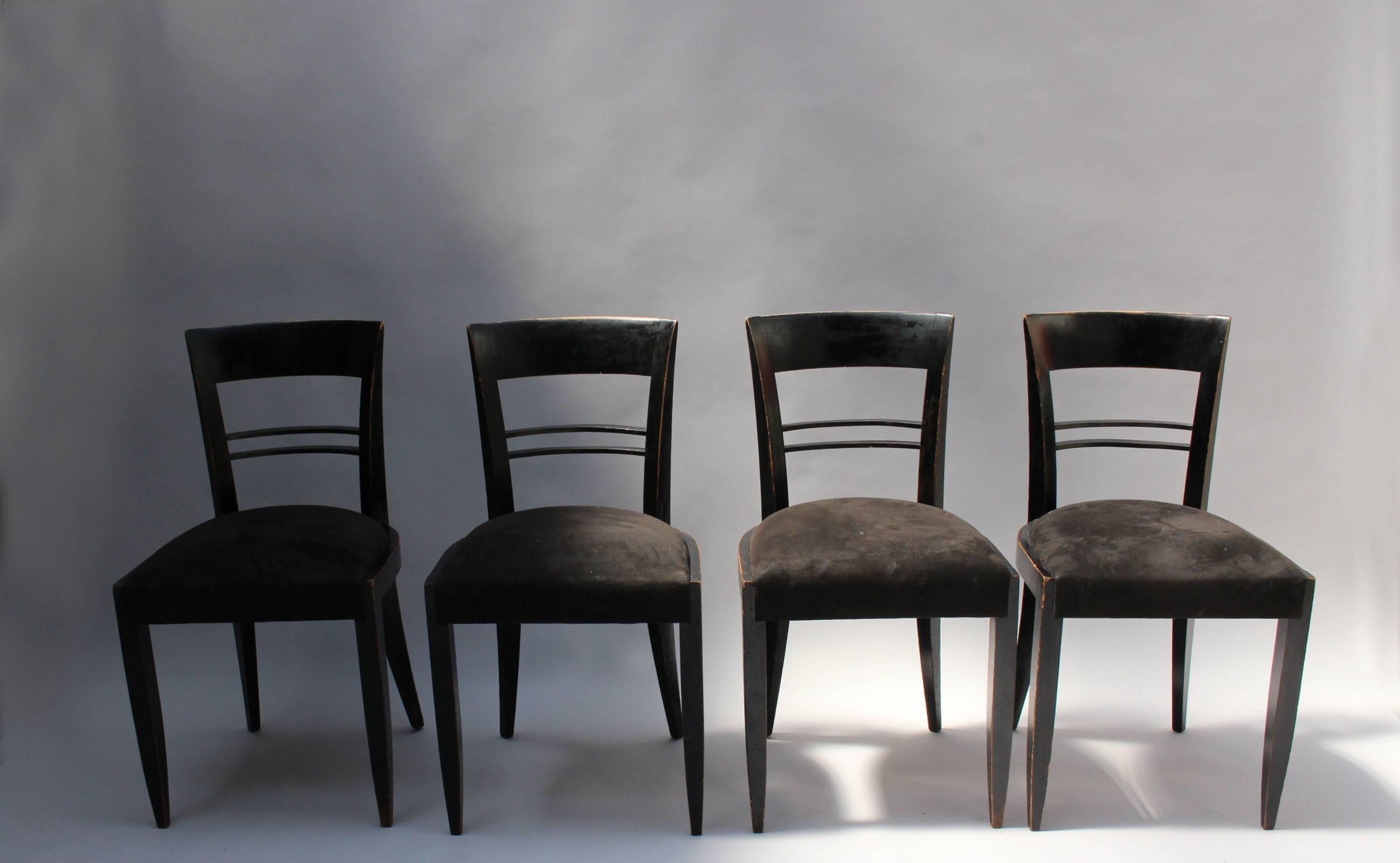 A set of six French Art Deco black lacquered dining chairs (four side and two armchairs) attributed to Adnet.